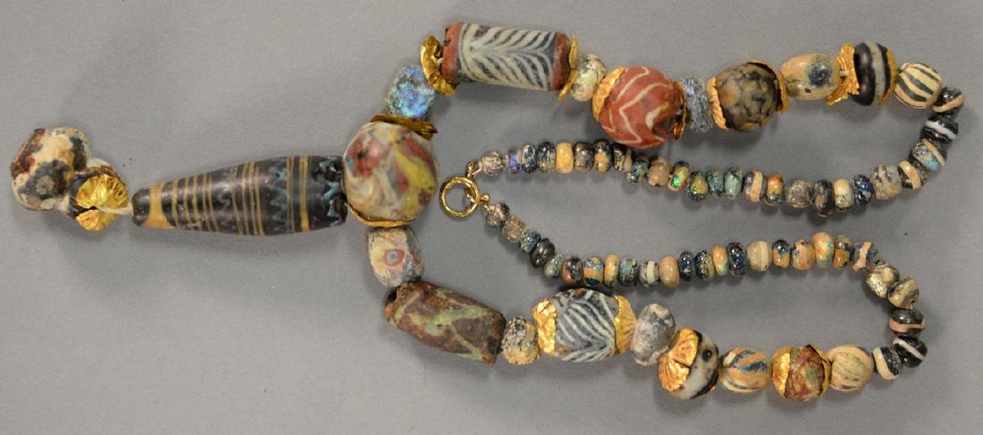Ancient Roman or Egyptian beads with gold clasp and: Ancient Roman or Egyptian beads with gold clasp and gold spacers. length 17 1/2 inches