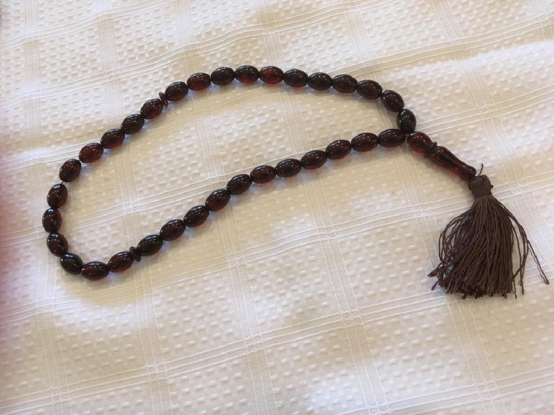 Cherry Amber Beads Necklace: 18â€ (45.5 cm) round and 4â€ (10 cm) pendant with tassel.
