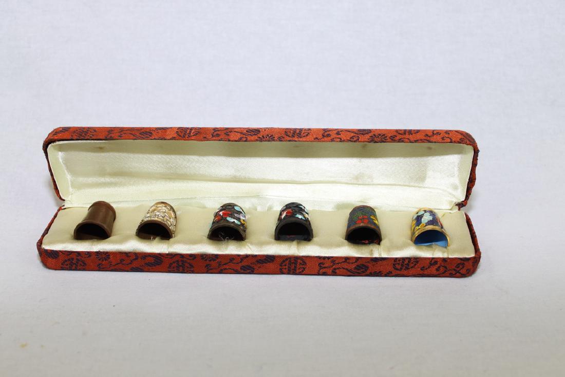 Six Thimbles in fitted silk case (Cloisonne, etc): H:1'' Dia 8''. Box 8.5''x1.9''