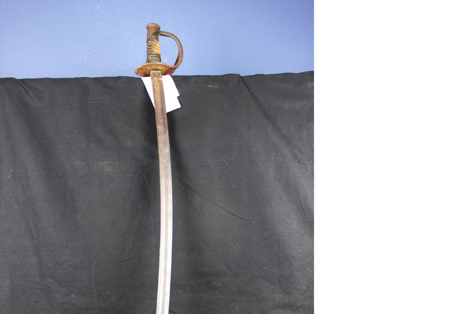 United States M-1906 Cavalry Saber: 40.25'' (34.5'' blade). Ricasso of saber marked "US JC" and "A.S. Co 1906" with flaming bomb. Saber grip exhibits loose wire wrap with loss and degradation with loss to leather grip.