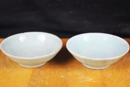 A pair of carved Qingbai 'floral' bowls