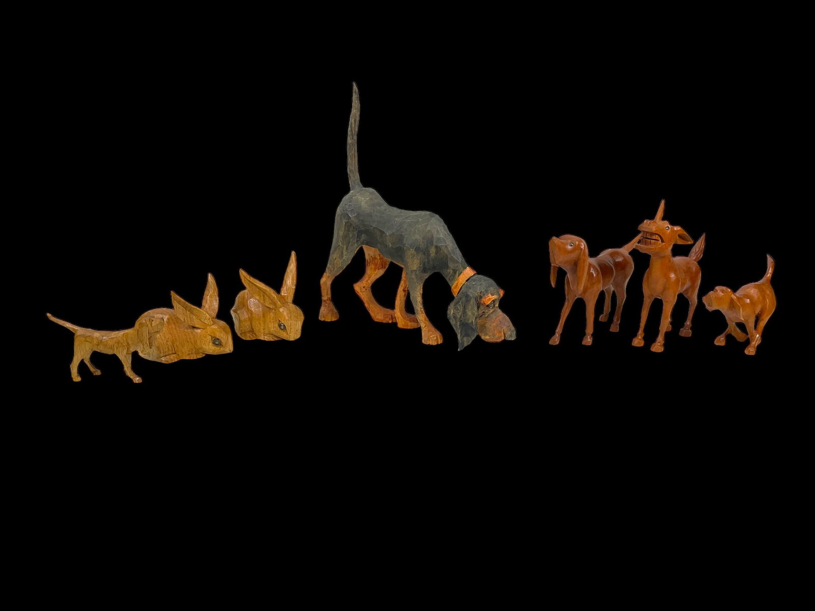 7-Signed Wood Carved Folk Art Animal Figures: 7-Signed Wood Carved Folk Art Animal Figures. Includes 2 bunnies that measure 2" tall and marked "WS" on bottoms, a donkey that is 3.75" tall and marked "WH" on bottom and 4 hunting dogs that are 1.5"