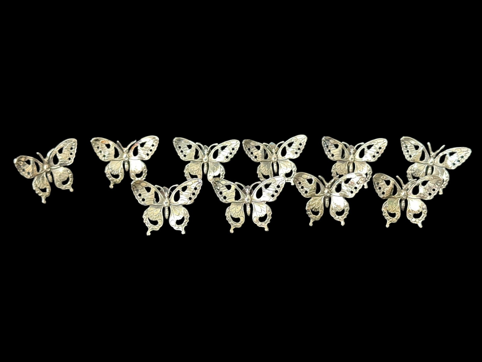 Set of 8 Fithian Silver Butterfly Table Place Markers: Set of 8 Fithian Silver Butterfly Table Place Markers. All measure 1.25" x 1.5" & are marked "800 FI 329" & weigh 58" grams in total.