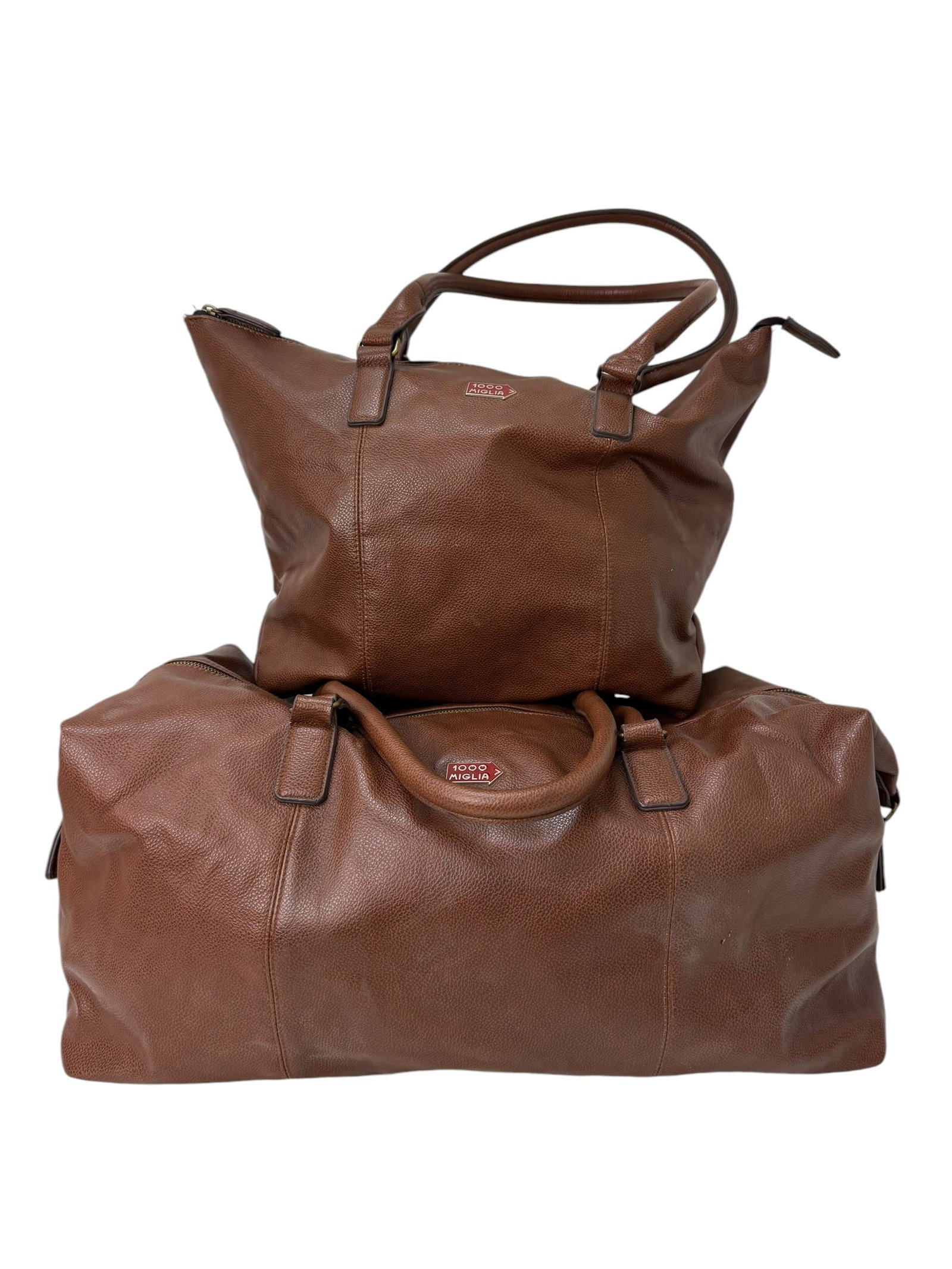 2 1000 Miglia Brown Leather Bags: 2 1000 Miglia Brown Leather Bags. Duffle bag measures approx. 10.5" H x 25" W x 13" D. Tote Bag measures approx. 11.5" H x 19" W x 8" D.