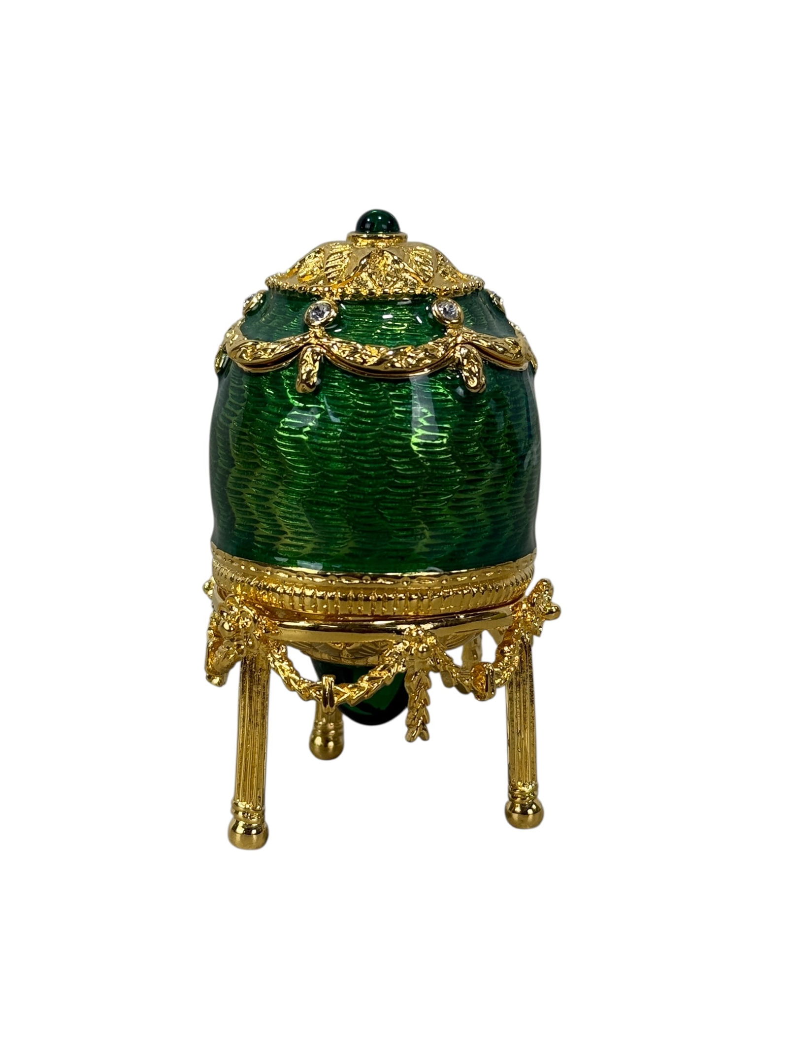 Faberge Anastasia Egg/Pendant on Stand in Green: Faberge Anastasia Egg/Pendant on Stand in Green. Guilloche enamel green. Made in Germany. Inside a faceted crystal pendant on a 17.5” gold plated chain. Egg on stand measures 2.75" H x 1.5" W x