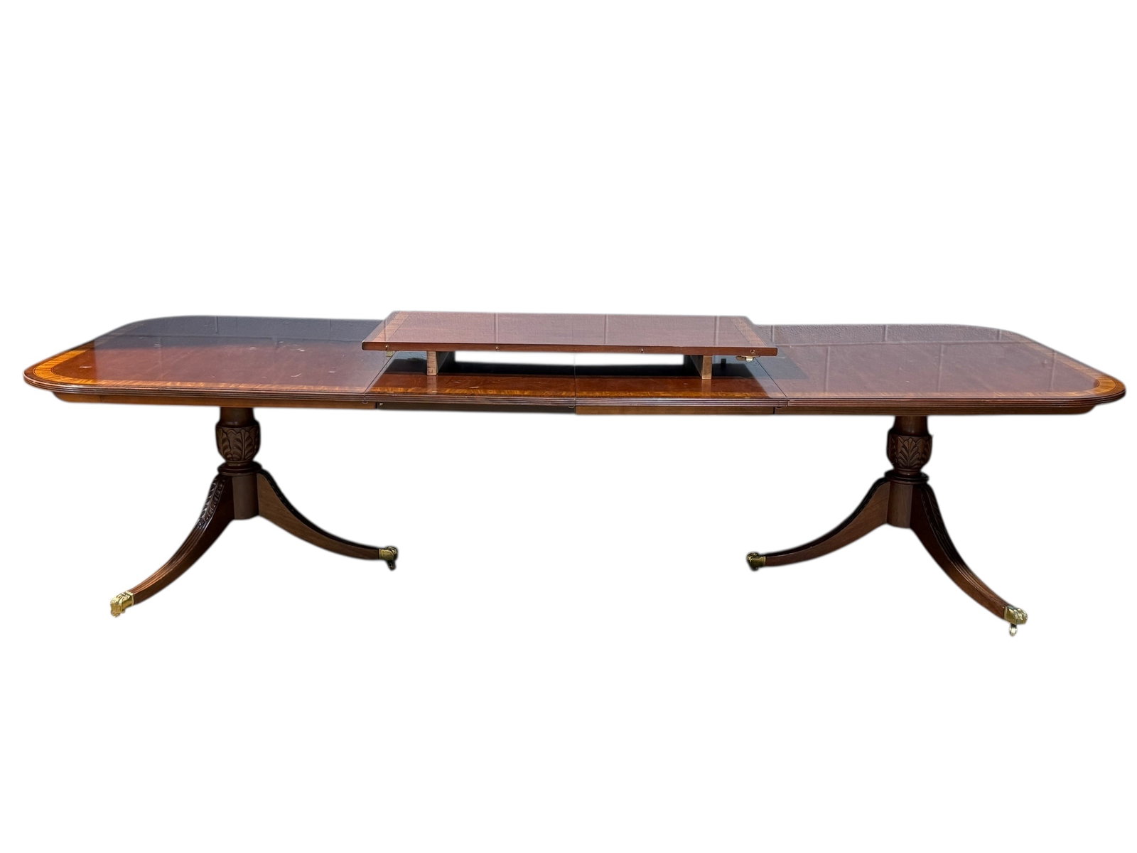 Georgian Style Mahogany Band Inlay Dining Table w/ 3 Leaves: Georgian Style Mahogany Band Inlay Dining Table w/ 3 Leaves. Flame mahogany with band inlay, double pedestal legs and brass claw feet. Measures 29.25" H x 76.5" W x 46.25" D. Table top measures 120.5"