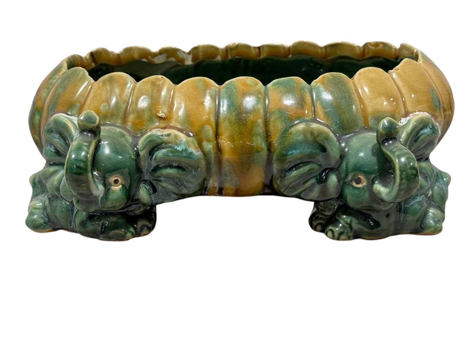 4 Elephant Majolica Pottery Planter: 4 Elephant Majolica Pottery Planter. Measures 3.5" H x 10.5" W x 9.75" D. In good condition.