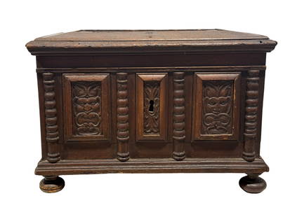 18th C. Italian Carved Wood Trunk: 18th C. Italian Carved Wood Trunk. Panels with carved faces and columns on the front. Measures 19" H x 27.5" W x 17.25" D. Condition reflects its age.