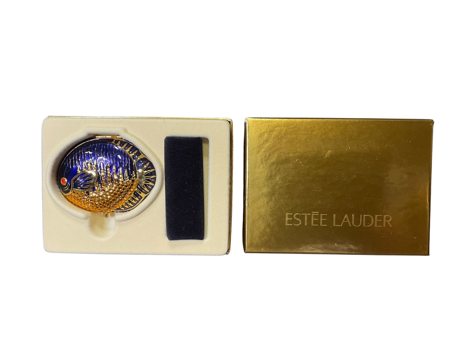 Estee Lauder "Purple Red Eyed Fish" Translucent Pressed Powder Compact: Estee Lauder "Purple Red Eyed Fish" Translucent Pressed Powder Compact. Measures 2" x 2-5/8" and is in original box with drawstring bag. Marked 1RLR-06