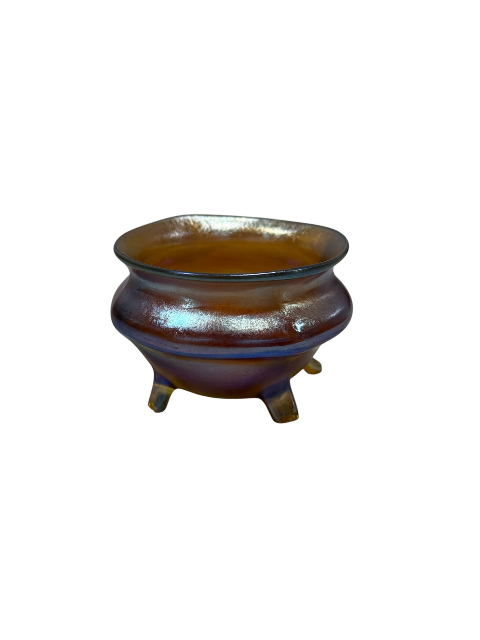 Signed L.C. Tiffany Favrile Glass Footed Salt: L.C. Tiffany Favrile Glass Footed Salt. Signed L.C.T. on the underside. Measures 1.5" H x 2.25" W x 2.25" D. In good condition.