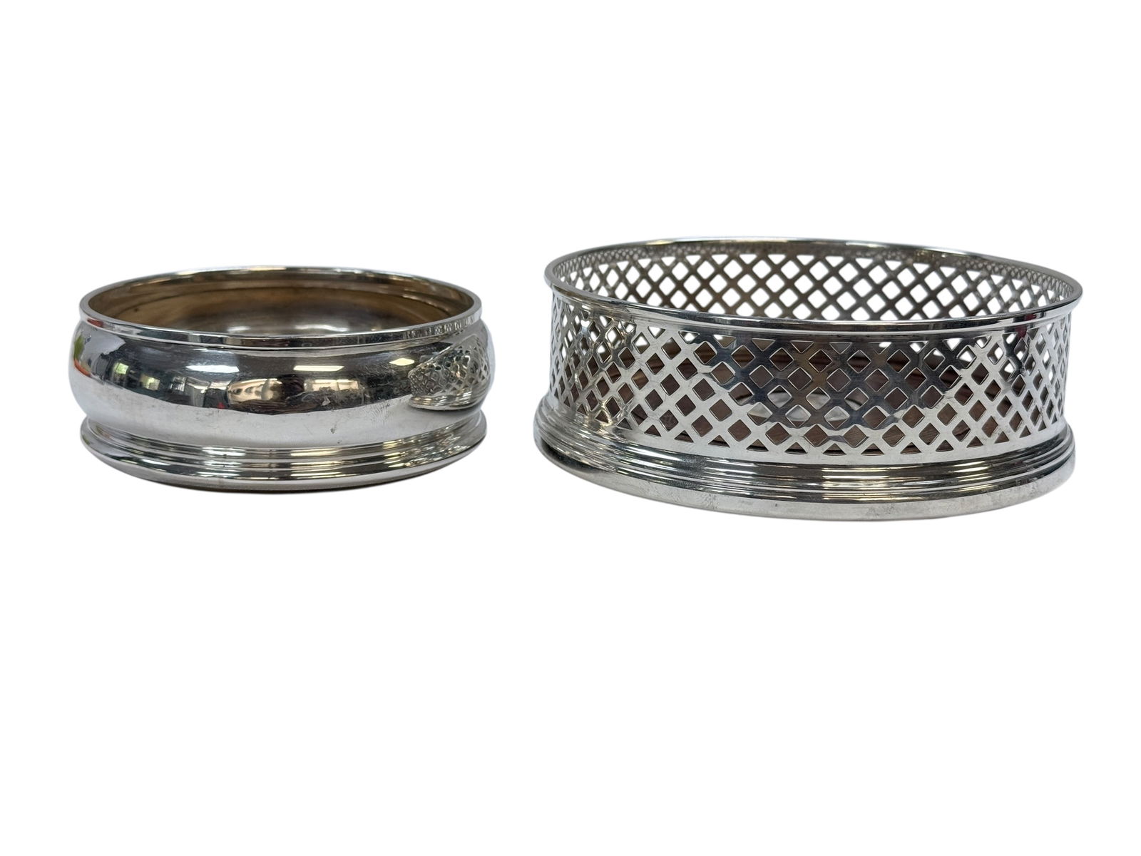 (2) Sterling Champagne Coasters w/ Wood Bottoms: (2) Sterling Champagne Coasters w/ Wood Bottoms. Both have sterling hallmarks. Measures 1.5" H x 3.75" Diameter & 1.75" H x 5" Diameter. Showing some wear on wood bottoms.