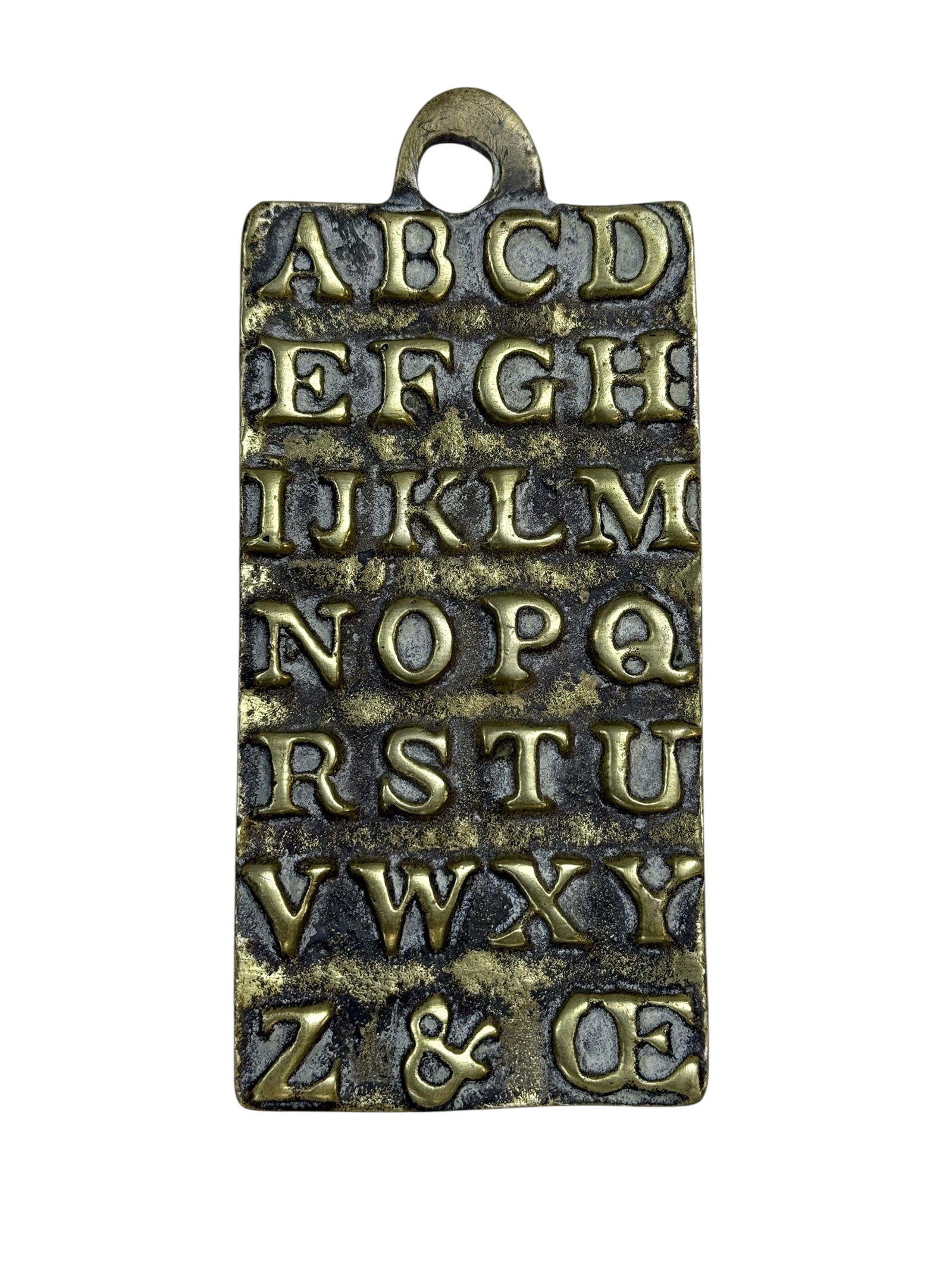 RARE 18th C. English Brass Horn Book: RARE 18th C. English Brass Horn Book. The rectangular tablet surmounted by hanging loop and cast in relief with the alphabet, inscribed verso 'St Paul's, AD 1729'. Measures 5.75" x 2.5". Condition ref