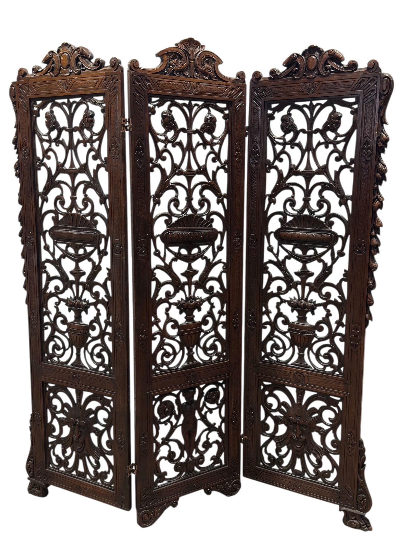 19th C. Italian Carved Walnut Folding Screen: This impressive 19th century Italian folding screen is finely carved from solid walnut, showcasing a richly layered program of classical and mythological ornament. The three hinged panels are deeply p