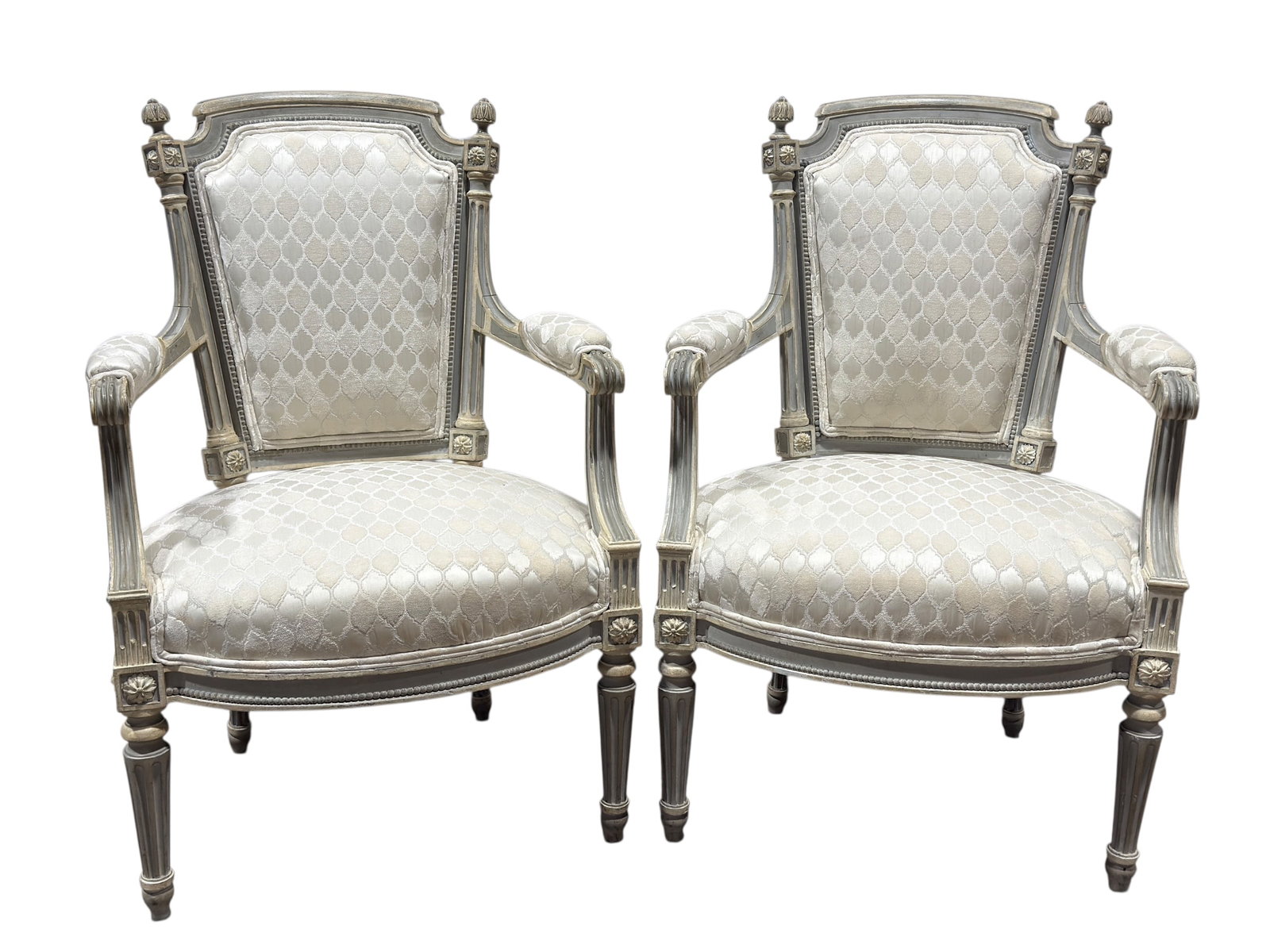 Pair of 19th C. French Louis XVI Painted Armchairs: A refined pair of 19th century French Louis XVI–style painted armchairs (fauteuils), exhibiting classic neoclassical proportions and elegant architectural detailing. Each chair features a shaped uph