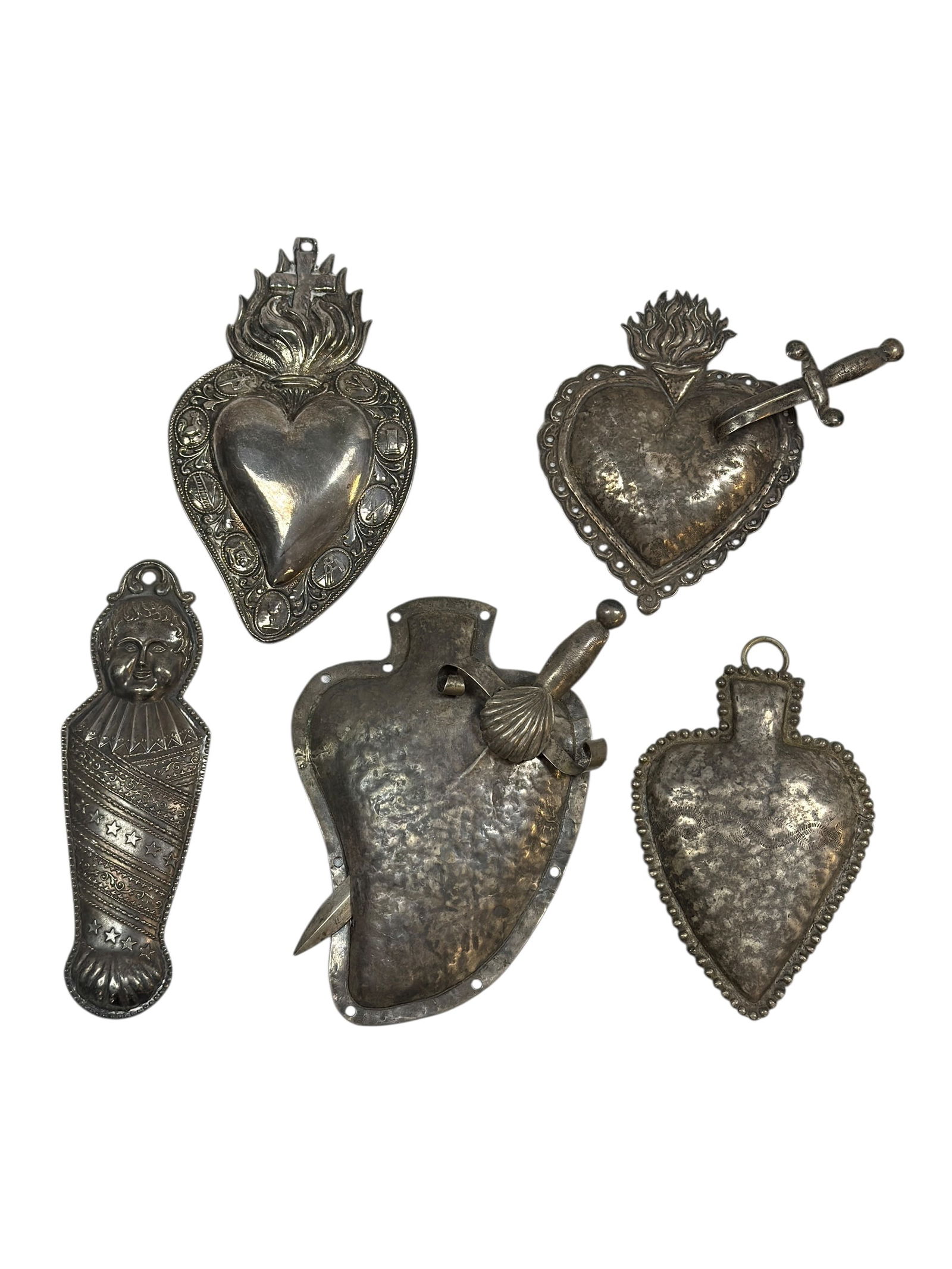 19th C. Mexican Silver Sacred Heart & Ex-Voto Milagro Group: A compelling 19th century Mexican silver religious grouping, consisting of six Sacred Heart and ex-voto forms, including repoussé and hand-worked examples. The group features traditional Sacred Heart