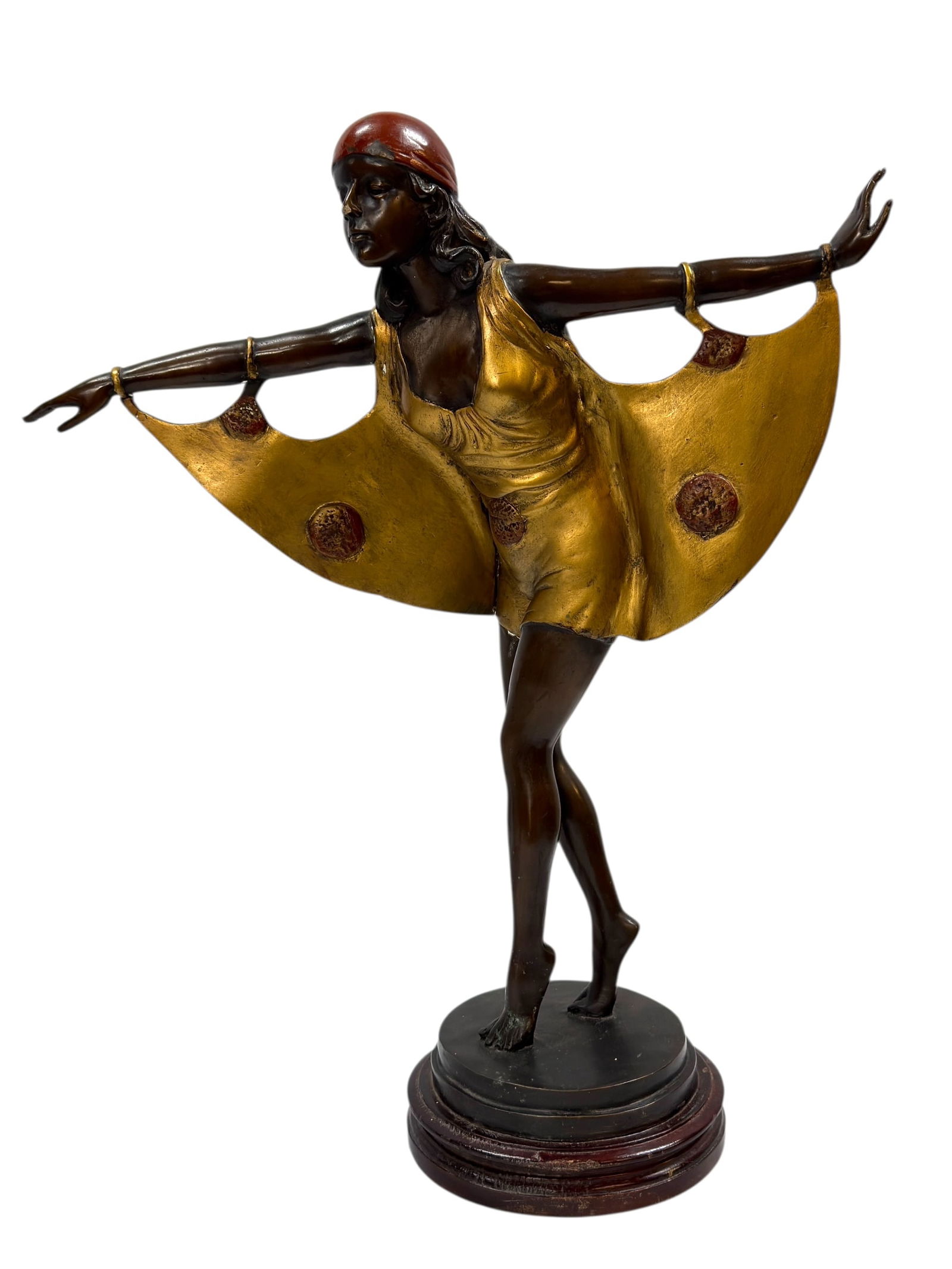 Circa 1920s–1930s Art Deco Cold-Painted Bronze Dancer: A striking Art Deco cold-painted bronze figural sculpture depicting a stylized dancer in mid-motion, arms extended gracefully to display flowing, wing-like drapery. The figure is rendered with elegant