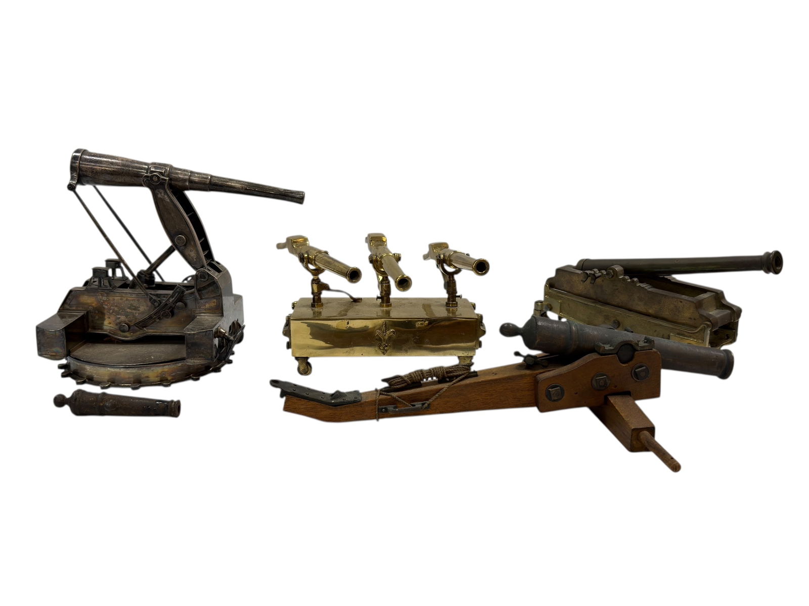 Group of Antique Cannon Models (19th–Early 20th Century): An engaging group of antique cannon models, showcasing a variety of miniature artillery forms likely dating from the 19th to early 20th century. The group includes a mechanically articulated metal can