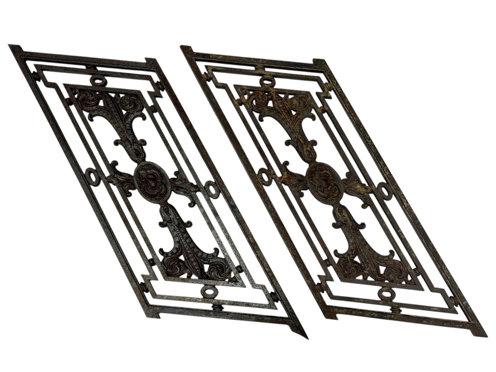 Pair of Antique Louis Sullivan Cast Iron Architectural Fragments: A striking pair of cast iron architectural fragments attributed to the Louis Sullivan school of design, exhibiting bold geometric framing combined with organic foliate and scroll motifs characteristic