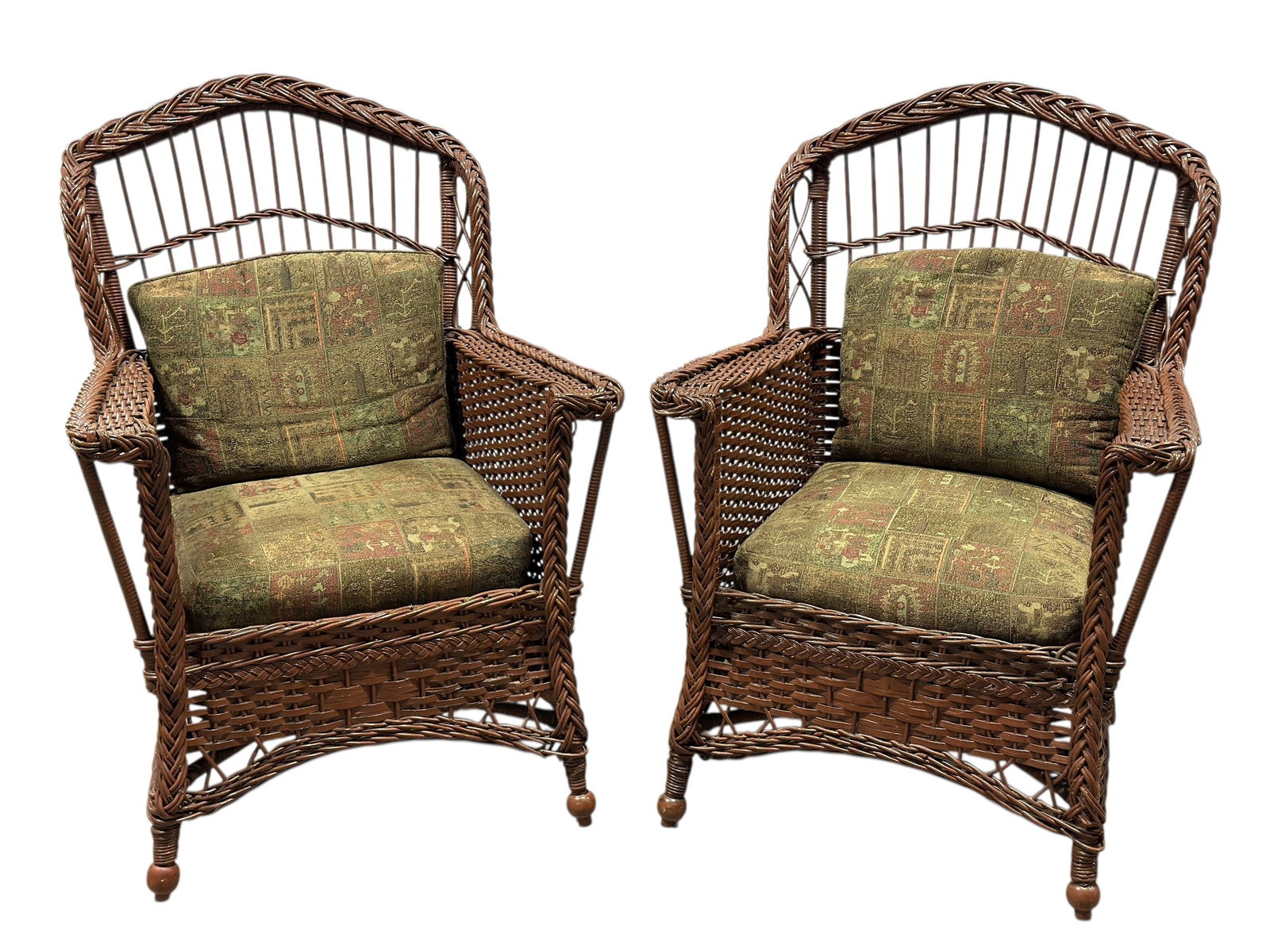 Pair of Circa 1910 Arts & Crafts Wicker Armchairs: Matching pair of early 20th century Arts & Crafts wicker armchairs, circa 1910. Each chair features a tightly woven wicker frame with braided crest rails, shaped arms, and ball-form front feet. The ba