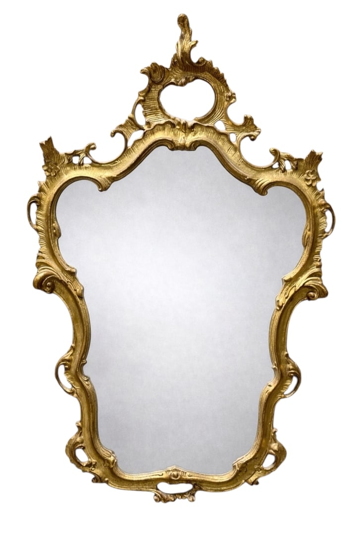 19th Century Rococo Revival Giltwood Wall Mirror: This 19th century Rococo Revival wall mirror is crafted from carved giltwood, featuring an ornate asymmetrical frame with scrolling acanthus leaves, pierced cartouches, and an openwork crest reflectin