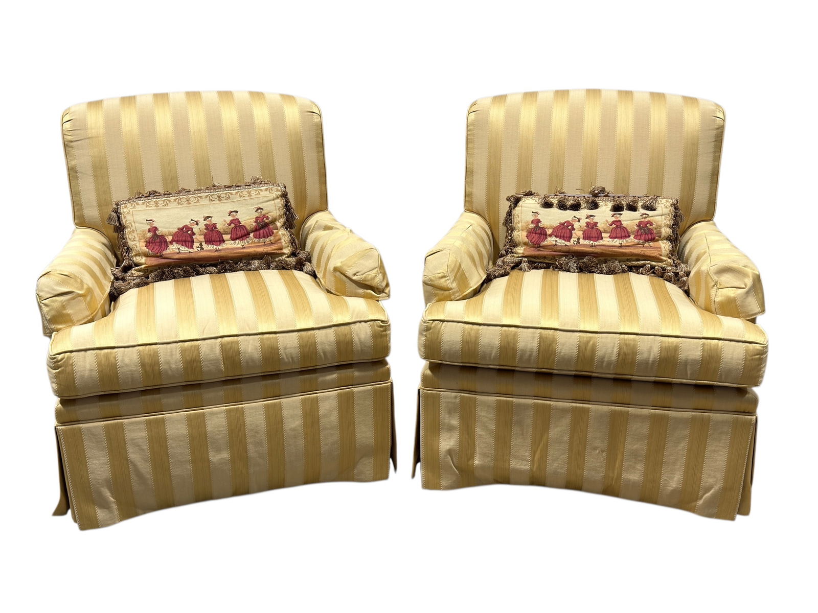 Pair of Kindel Fine Upholstered Slipper Armchairs: This elegant pair of Kindel fine upholstered armchairs features classic rolled arms and a tailored skirted base, upholstered in a gold and cream striped fabric with coordinating decorative accent pill