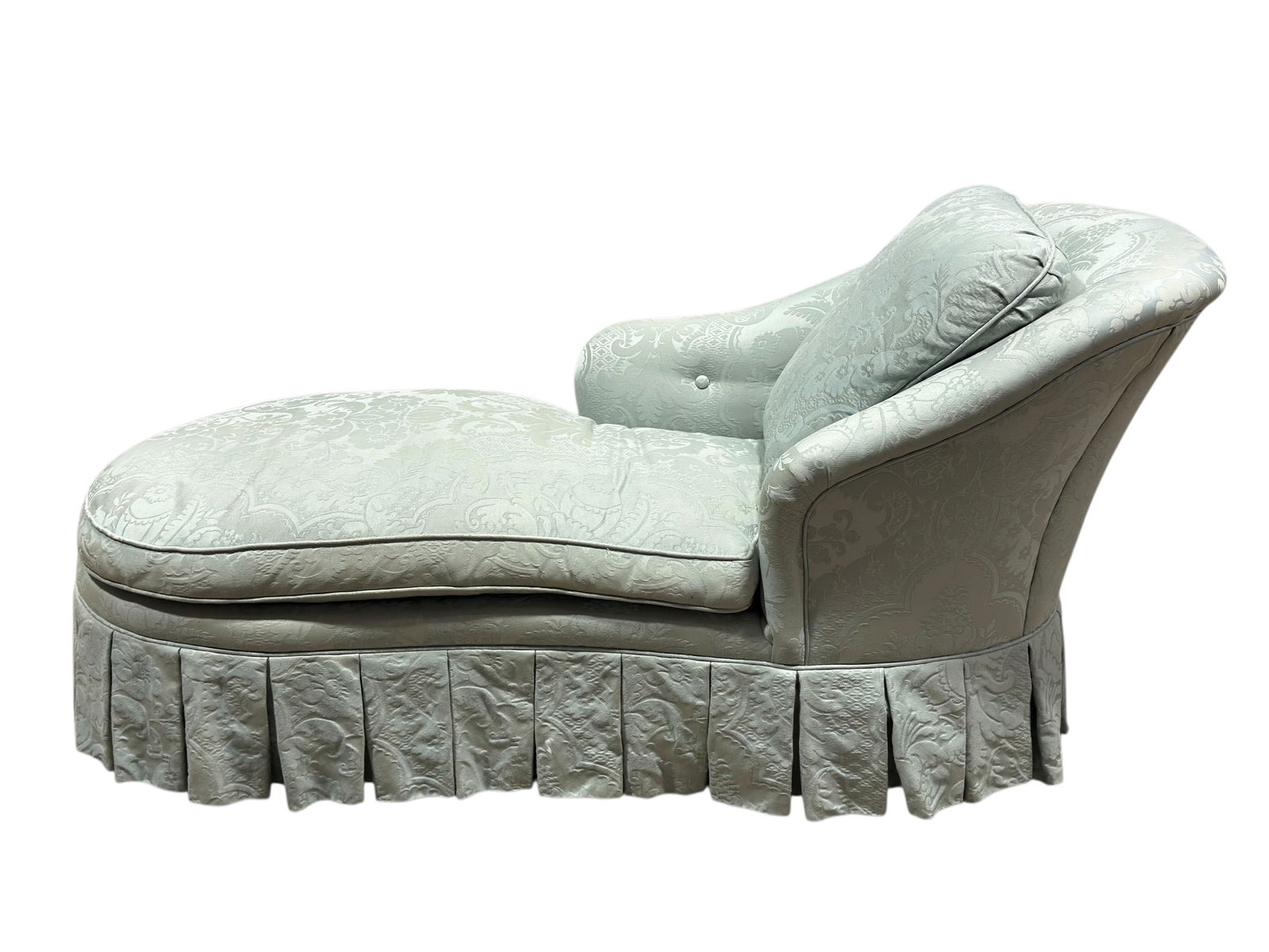 Vintage Upholstered Chaise Lounge: A comfortable vintage chaise lounge, upholstered in a pale blue damask-patterned fabric with an elegant silhouette featuring a rolled upper back that tapers gracefully into a deep chaise section and a