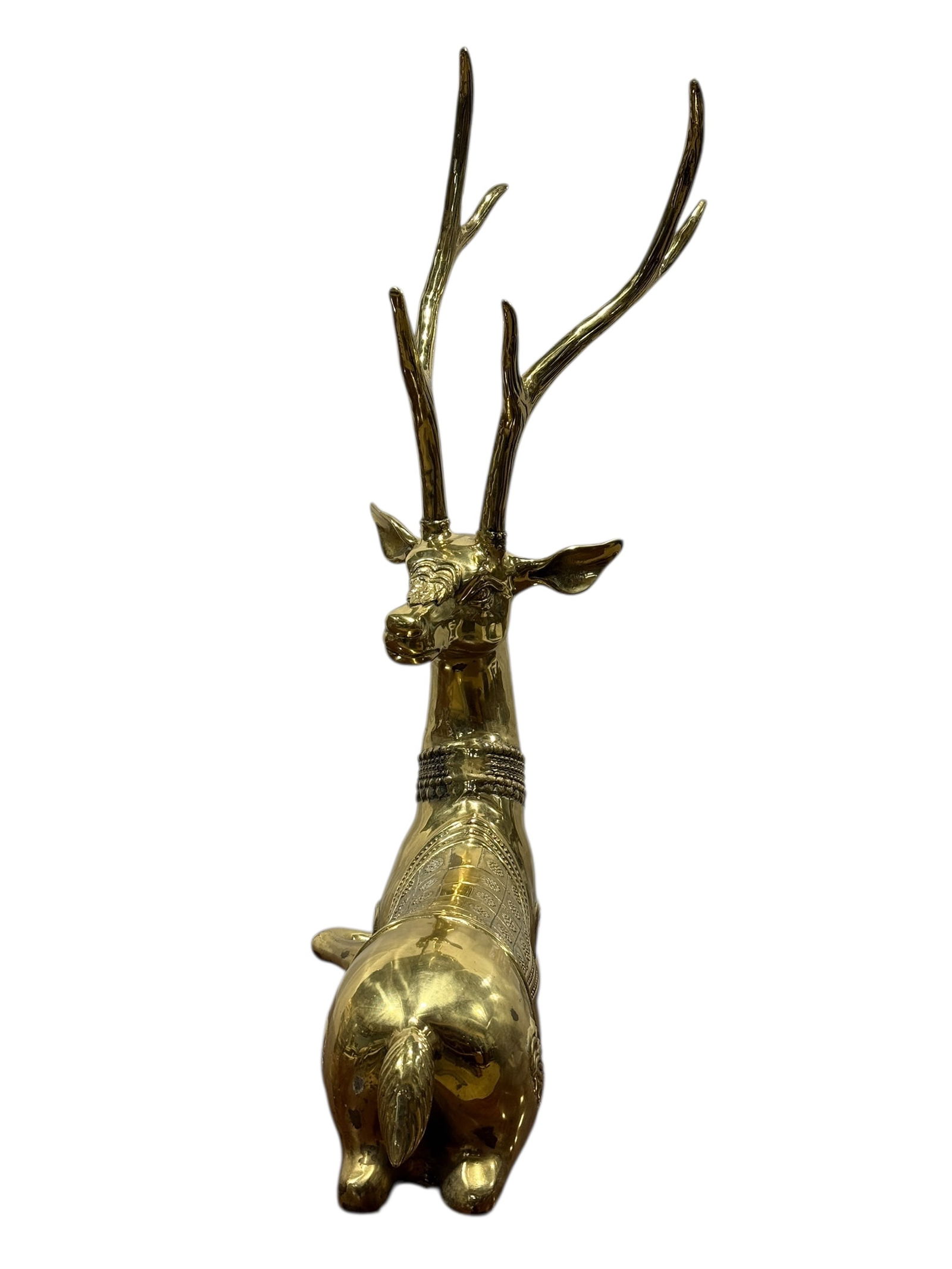 Large Brass Seated Deer/Stag Sculpture: A substantial brass deer or stag sculptures depicting recumbent figures with tall branching antlers and decorative detailing on the bodies, cast with stylized patterns and raised ornament around the n