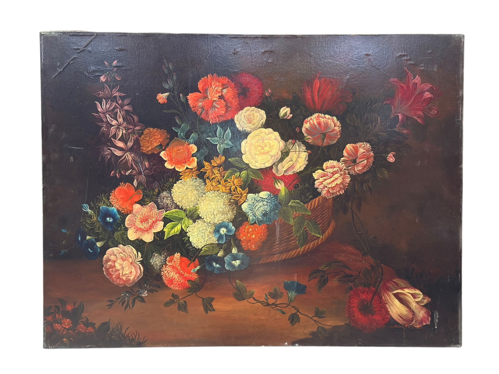 20th C. Signed Floral Still Life Oil on Canvas: Oil on canvas still life depicting a lush basket arrangement of roses, carnations, hydrangea, and other blooms rendered in rich reds, creams, blues, and greens against a dark, atmospheric ground; the