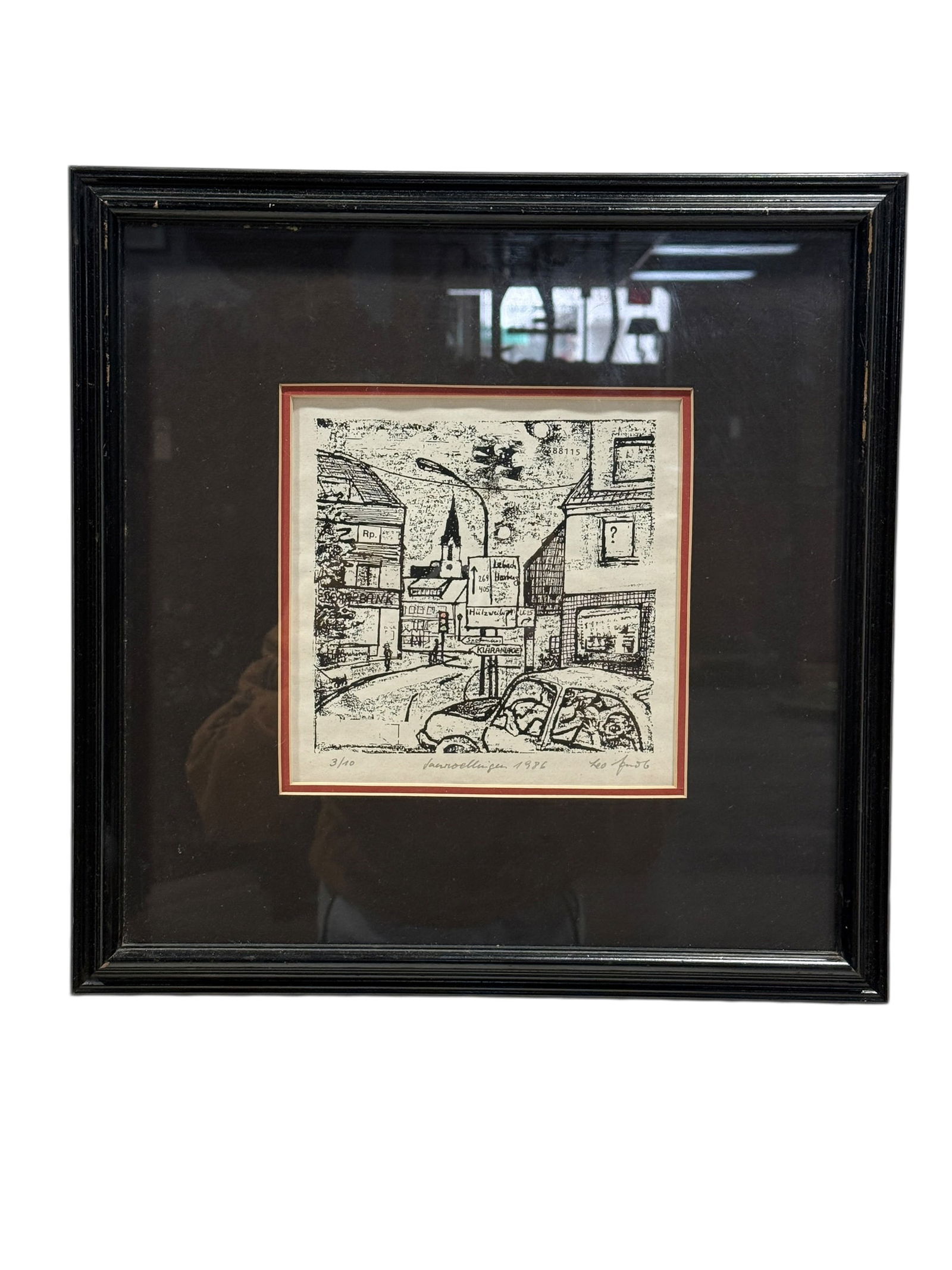 Signed Leo 1986 Limited Edition Janroelligen Street Scene Print: This limited edition black-and-white print depicts a stylized European town street scene with buildings, directional signage, a compact car in the foreground, and pedestrians rendered in an expressive