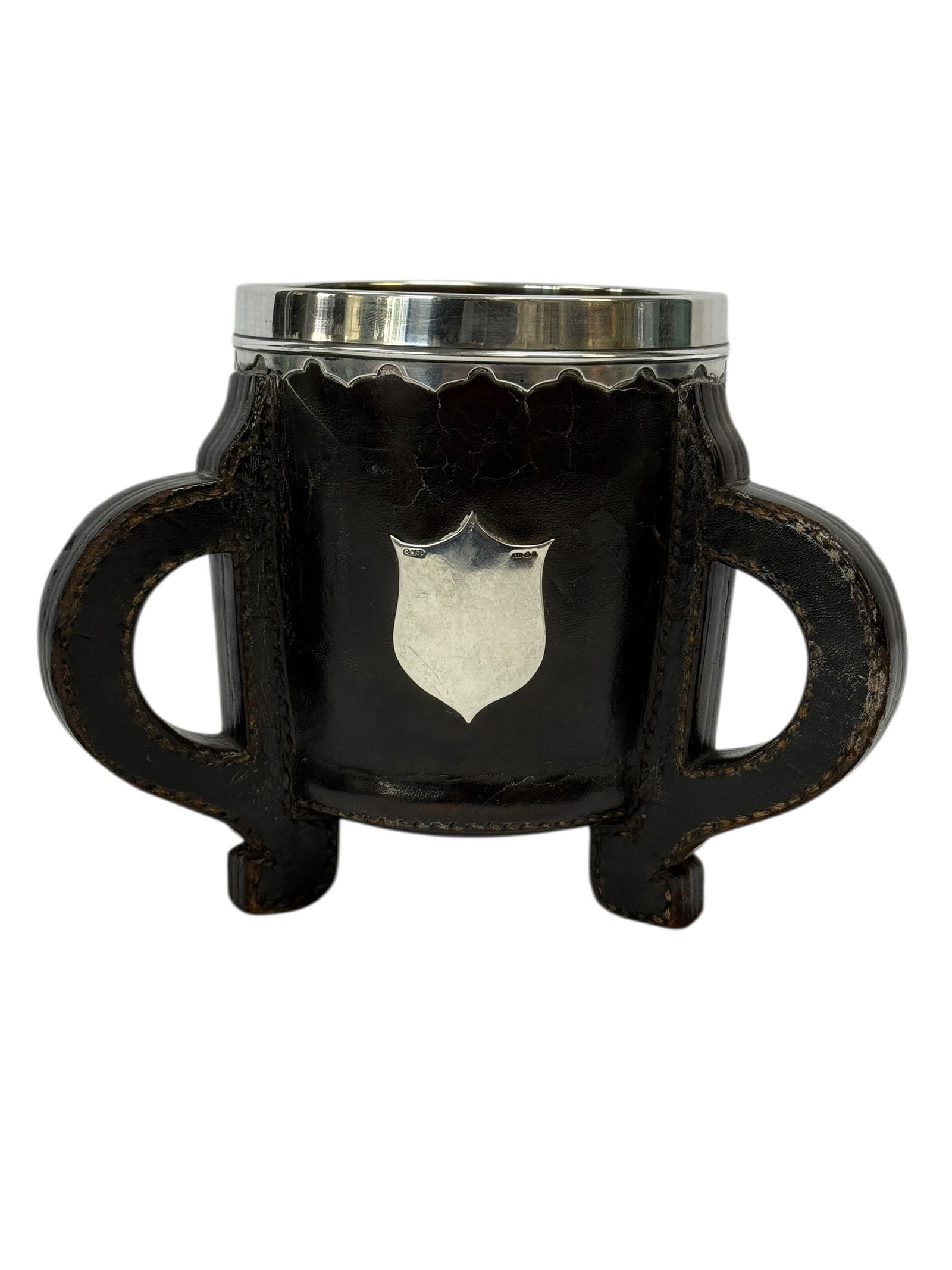 19th C. Arts & Crafts Gorham Sterling & Leather Wrapped Copper Loving Mug: This late 19th century Arts & Crafts loving mug features a copper body fully wrapped in dark leather with applied stitched construction, standing on an integrated footed base with opposing openwork ha
