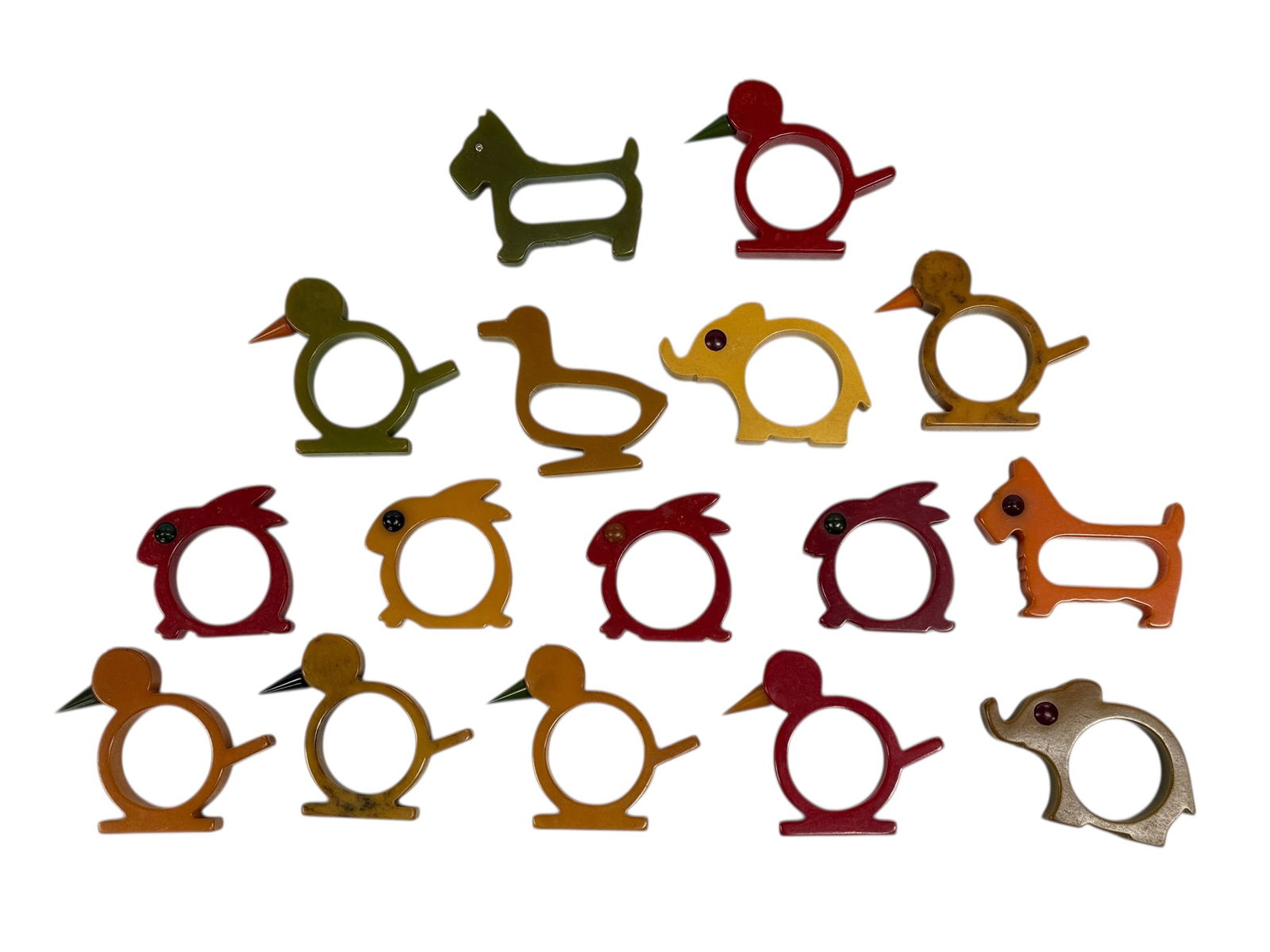 Collection of 16 Vintage Bakelite Animal Napkin Rings: Charming mid-century collection of 16 vintage Bakelite napkin rings in whimsical animal and bird forms, including ducks, roosters, elephants, and terrier-style dogs, all in classic marbled and solid c