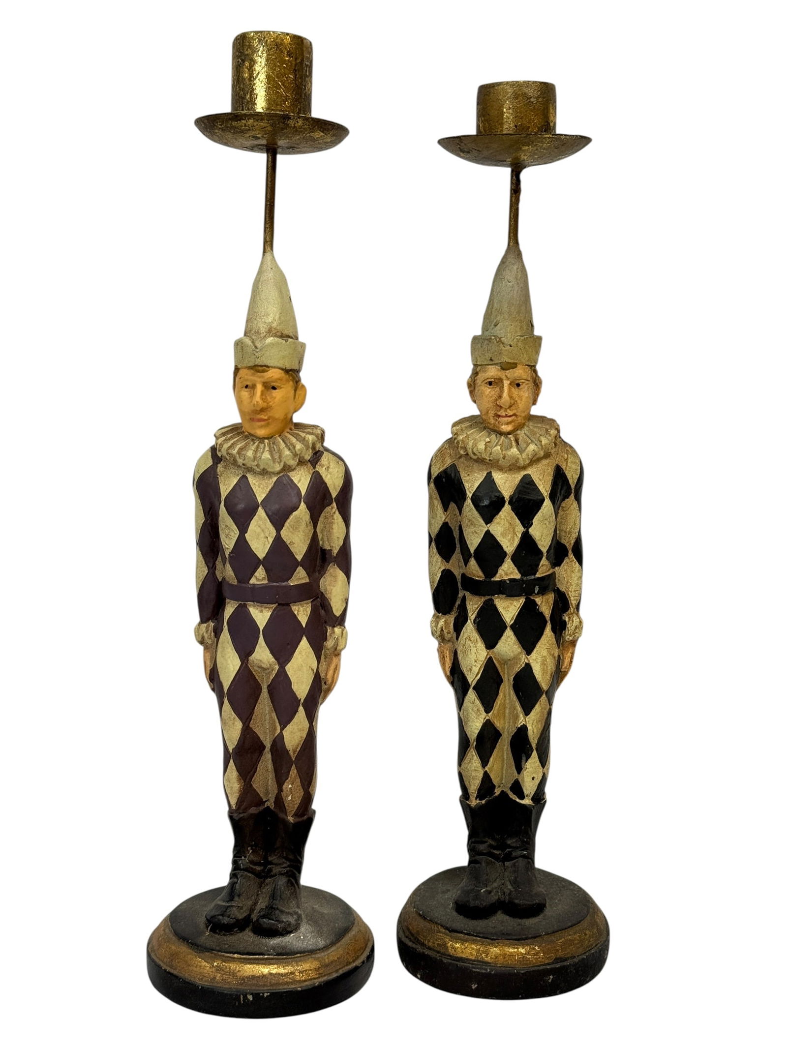 (2) Harlequin Figural Candleholders: (2) charming decorative harlequin figural candleholders, each modeled as a standing jester in traditional diamond-pattern costume, one in burgundy and cream and the other in black and cream, both topp