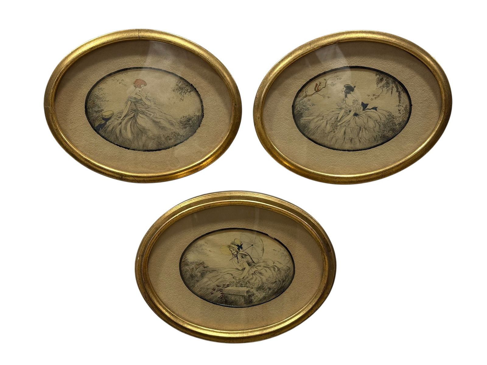 (3) c. 1920s Icart-Style Art Deco Oval Portrait Prints in Gilt Frames: Charming group of three oval Icart-style Art Deco portrait prints, each depicting an elegant young woman in flowing 18th-century inspired dress rendered in the romantic, delicate manner associated