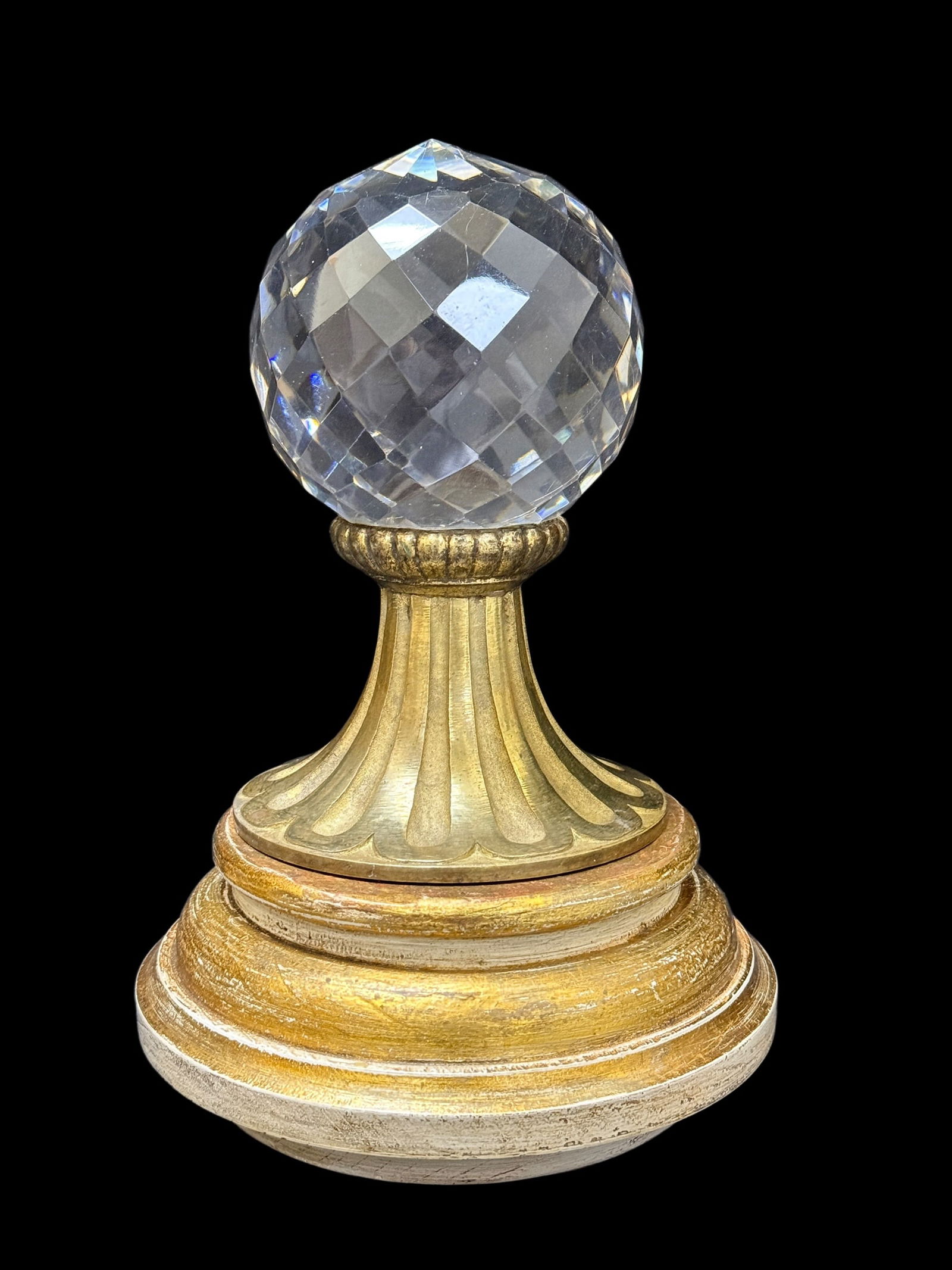 19th C. Faceted Cut Crystal Newel Post Finial on Giltwood Base: Impressive late 19th century newel post finial featuring a large faceted cut crystal sphere, richly hand-cut in a diamond and panel pattern that beautifully refracts light, mounted within a fluted gil