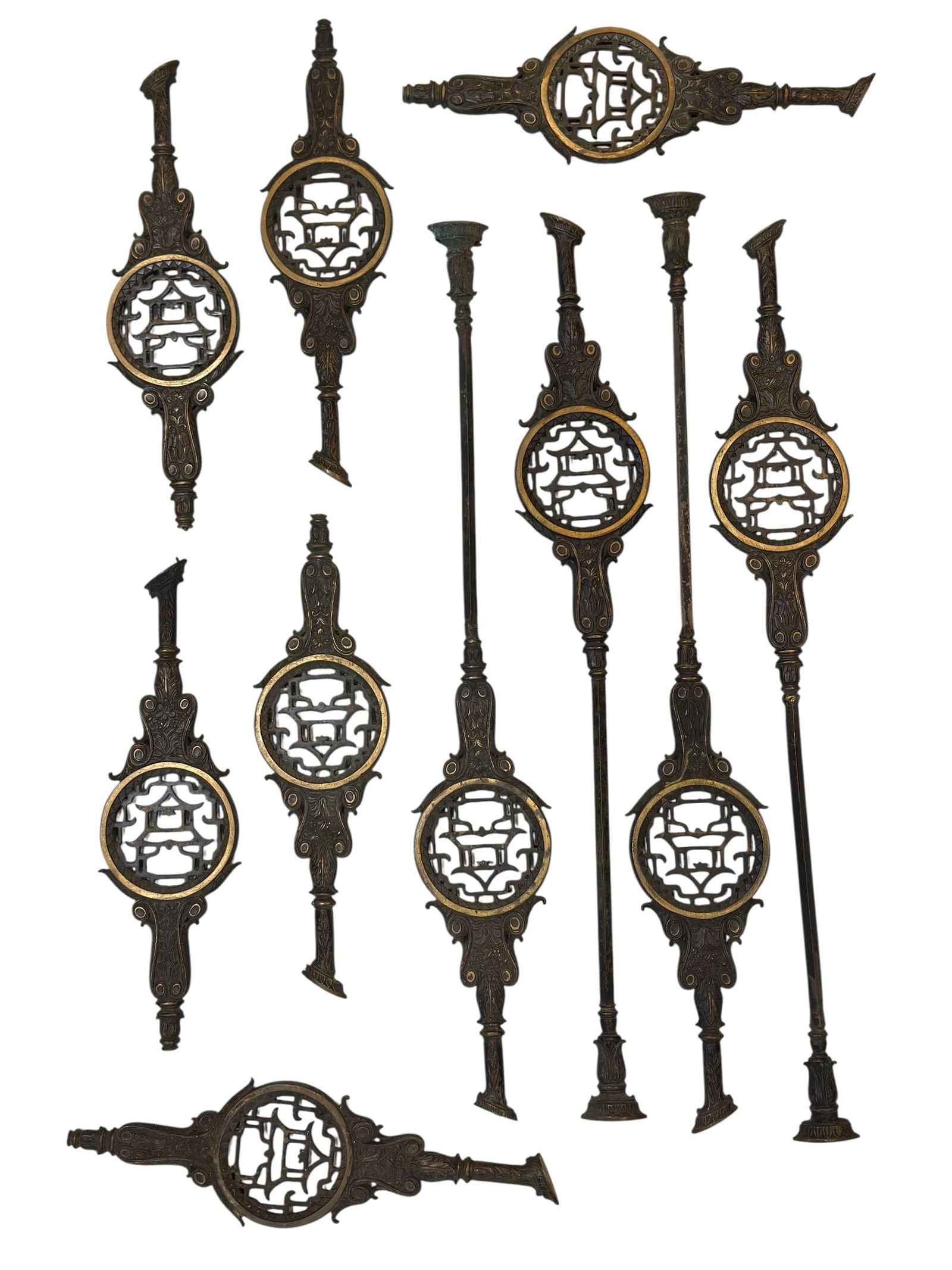 (10) 20th C. Bronze Asian Style Architectural Stair Balusters: Decorative group of ten Asian style bronze architectural stair balusters, each cast with an ornate openwork circular medallion featuring a stylized pagoda or pavilion motif within a geometric border,