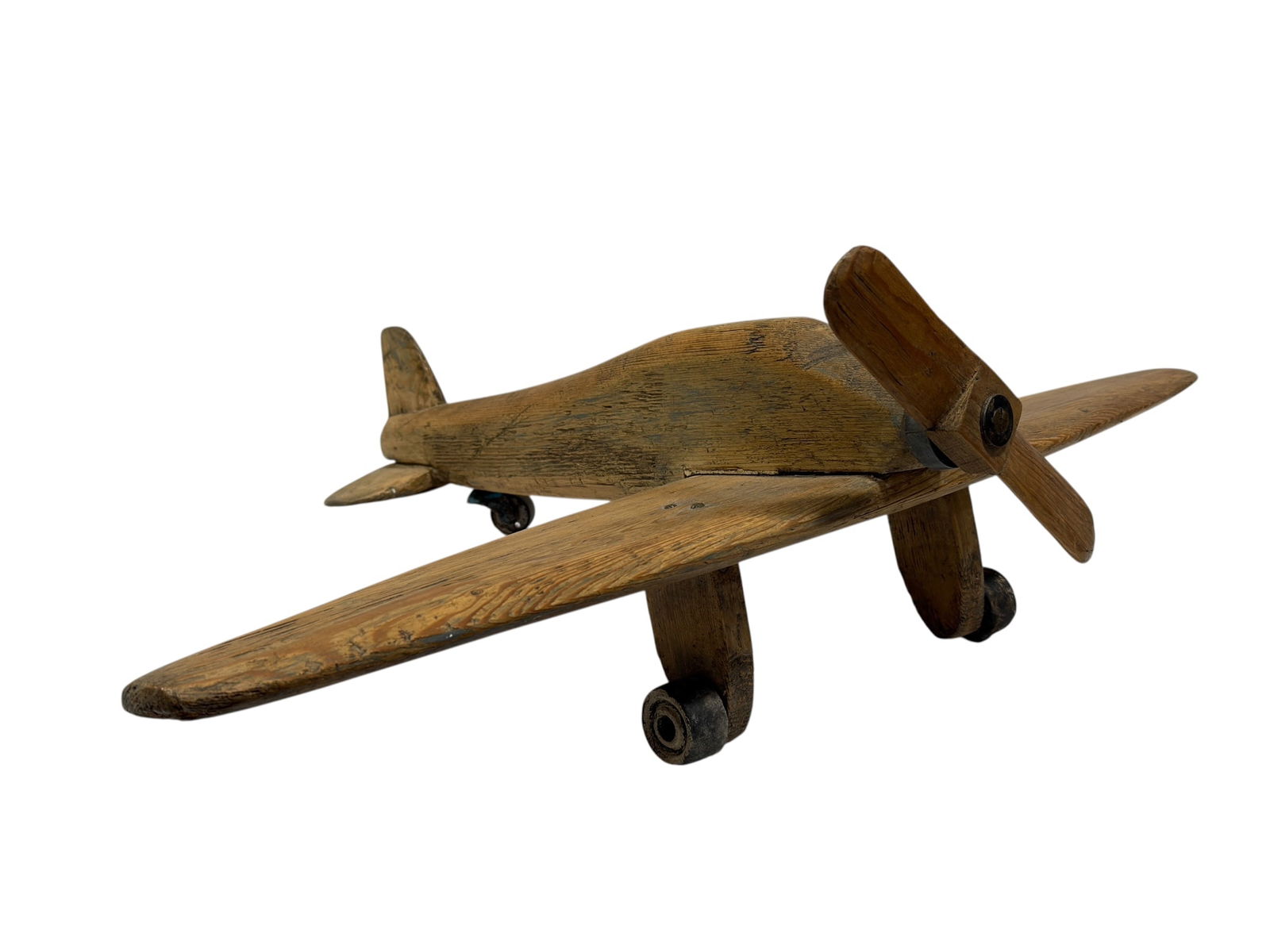 Cir 1940s Folk Art Carved Wood Toy Airplane: Charming early to mid-20th century folk art hand-carved wooden toy airplane, featuring a solid carved fuselage with pronounced wood grain, broad fixed wings, carved tail fin and stabilizer, and a