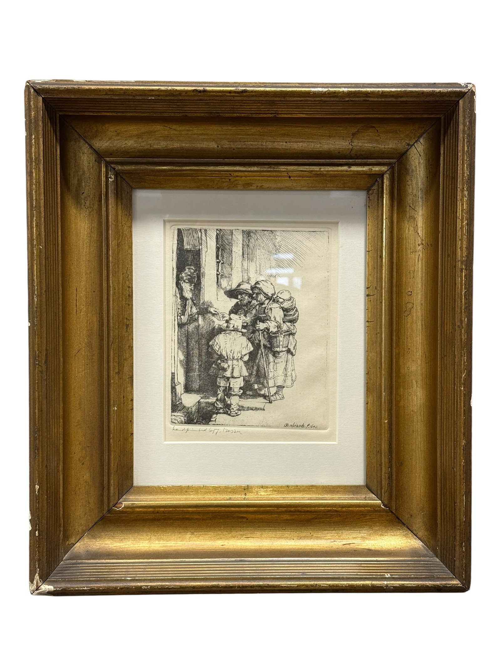 Signed The Beggars Receiving Alms at the Door Etching After Rembrandt van Rijn: Framed etching after Rembrandt van Rijn’s 1648 work The Beggars Receiving Alms at the Door, depicting a small group of travelers gathered at a doorway as a robed figure distributes alms, rendered wi
