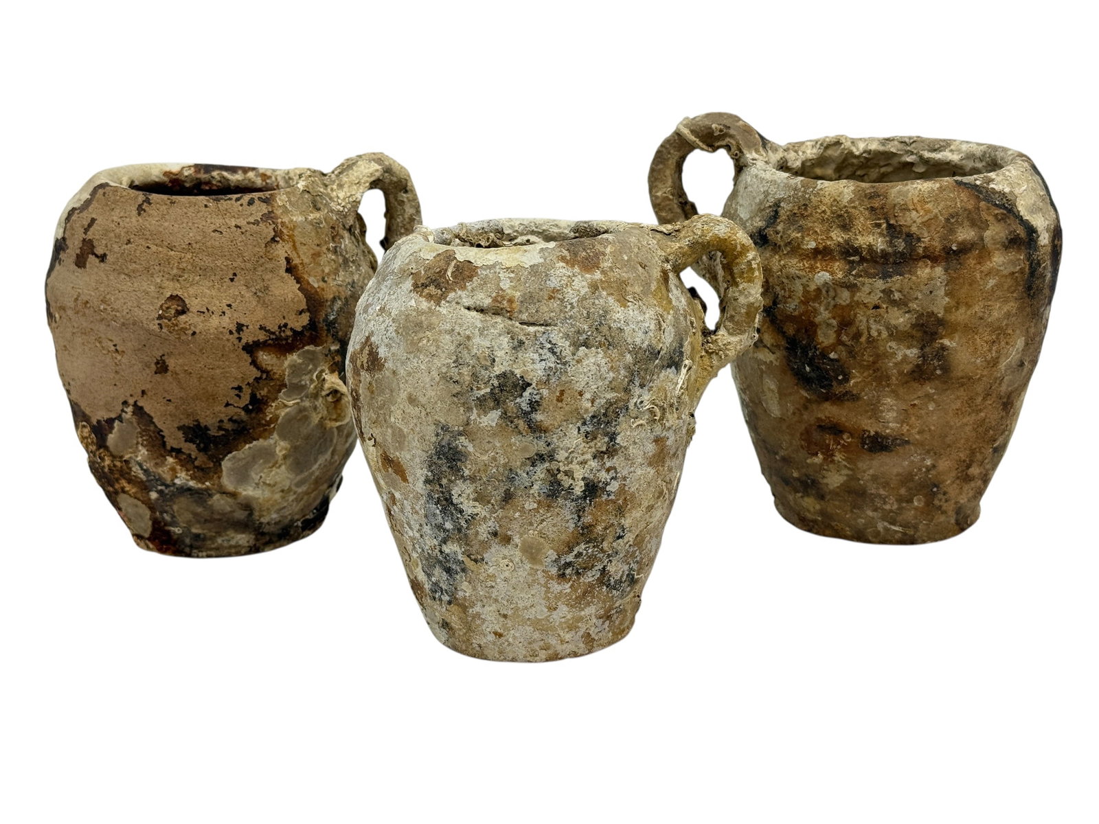 (3) 18th C. Shipwreck Recovered Pottery Jugs w/ Marine Encrustation: Group of three 18th century pottery jugs recovered from a marine shipwreck site, each of bulbous ovoid form with narrow mouth and applied loop handle, the surfaces heavily encrusted with marine growth