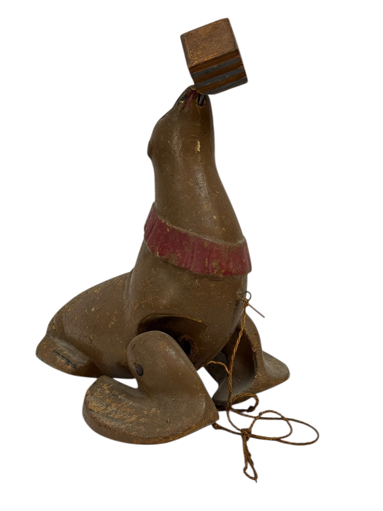 1940s Ramp Walker Seal Pull Toy w/ Block: A charming mid-20th century ramp walker pull toy depicting a seal balancing a block on its nose, likely dating to the 1940s and constructed of molded composite material with painted surface, featuring