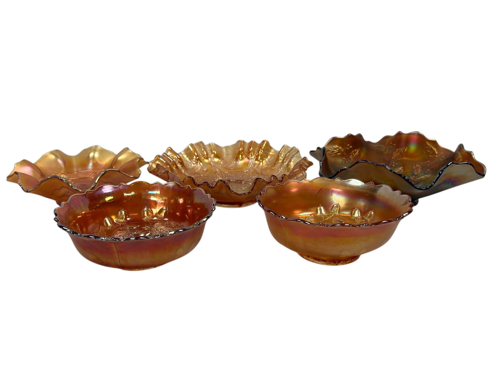 (5) Early 20th C. Fenton Carnival Glass Bowls: A vibrant and attractive group of five early 20th century Fenton carnival glass bowls, each displaying classic marigold iridescence with rich golden, amber, and rainbow hues, including examples in the