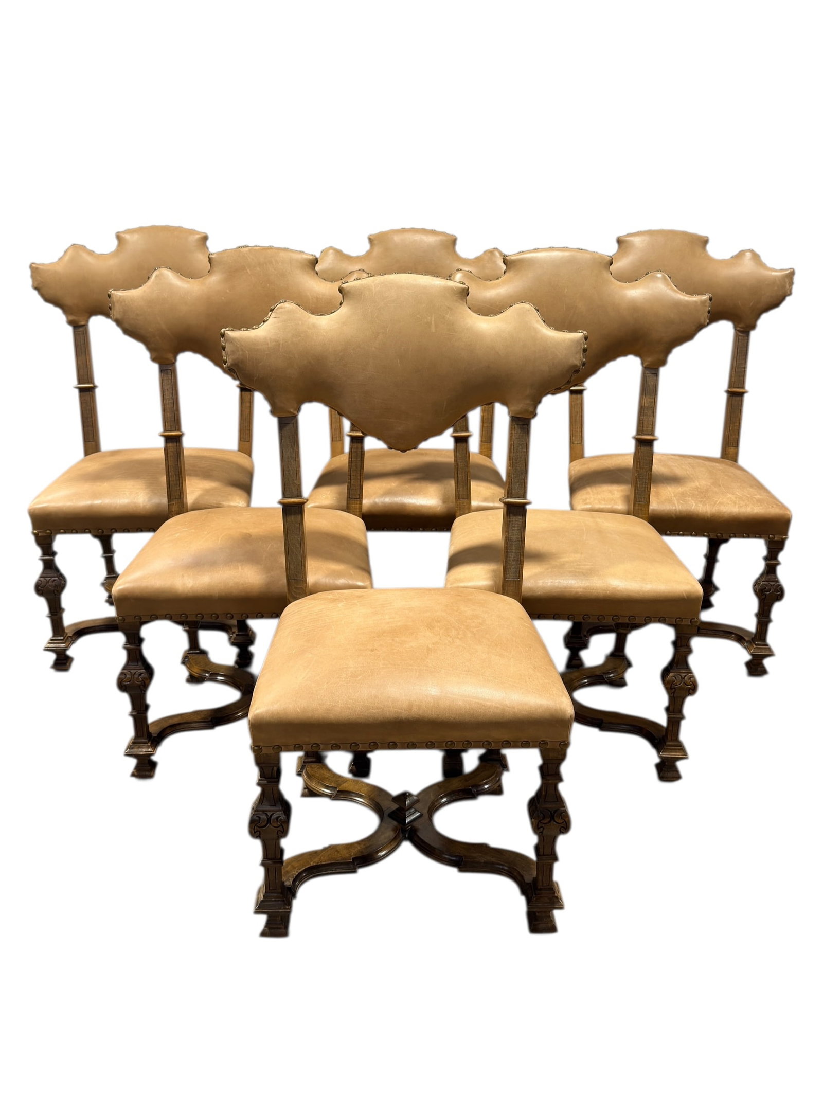 Set of 6 Italian Walnut & Studded Leather Shaped Back Dining Chairs: A striking set of six Italian walnut dining chairs featuring distinctive shaped backs upholstered in warm tan leather with decorative brass stud trim, the frames crafted in richly toned walnut with ca