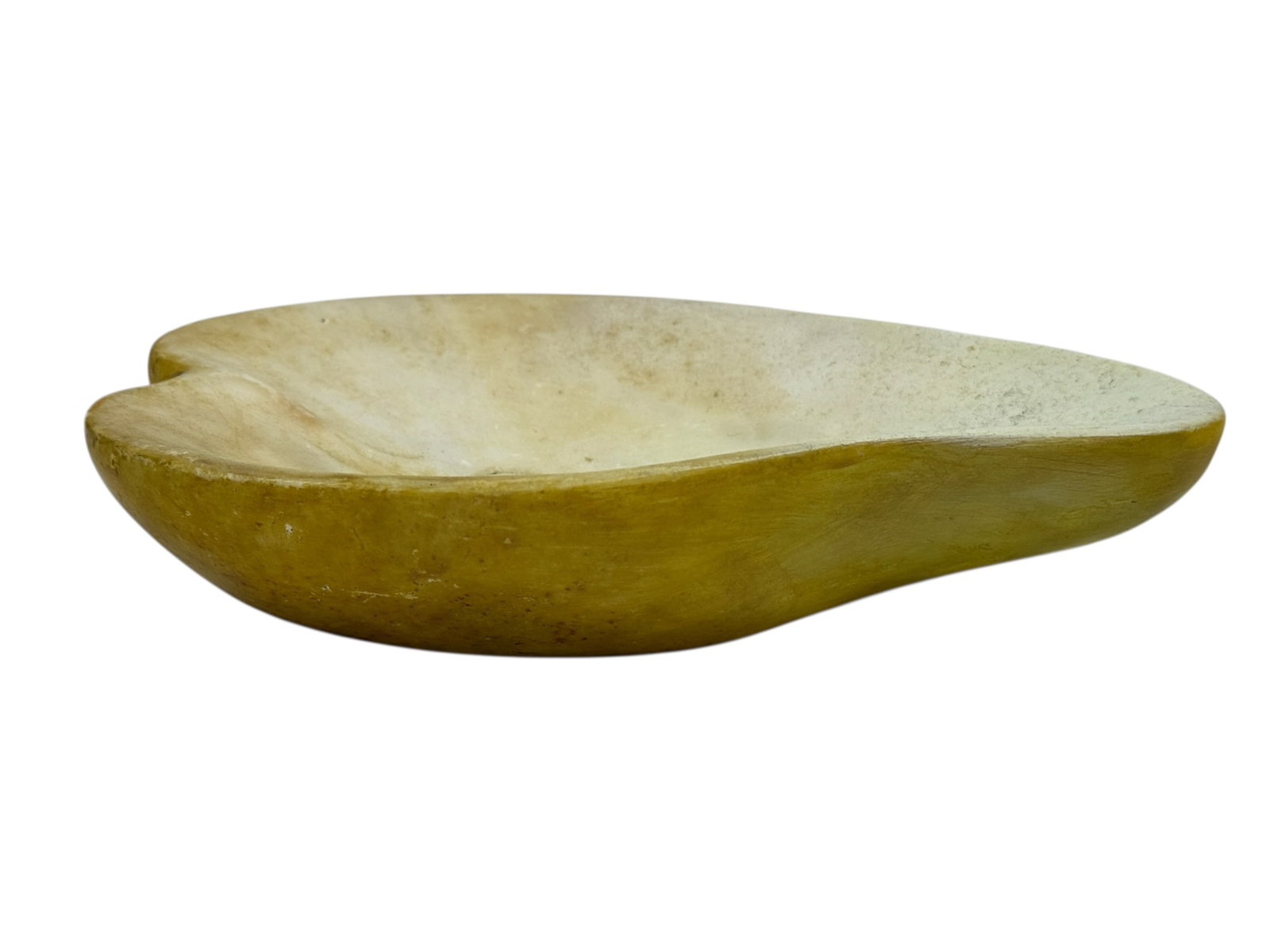 Mid-20th Century Italian Stone Half Pear Form Bowl: A charming and sculptural mid-20th century Italian stone bowl modeled in the form of a half pear, the exterior rendered in a warm yellow-toned stone with natural mottling and organic coloration, while