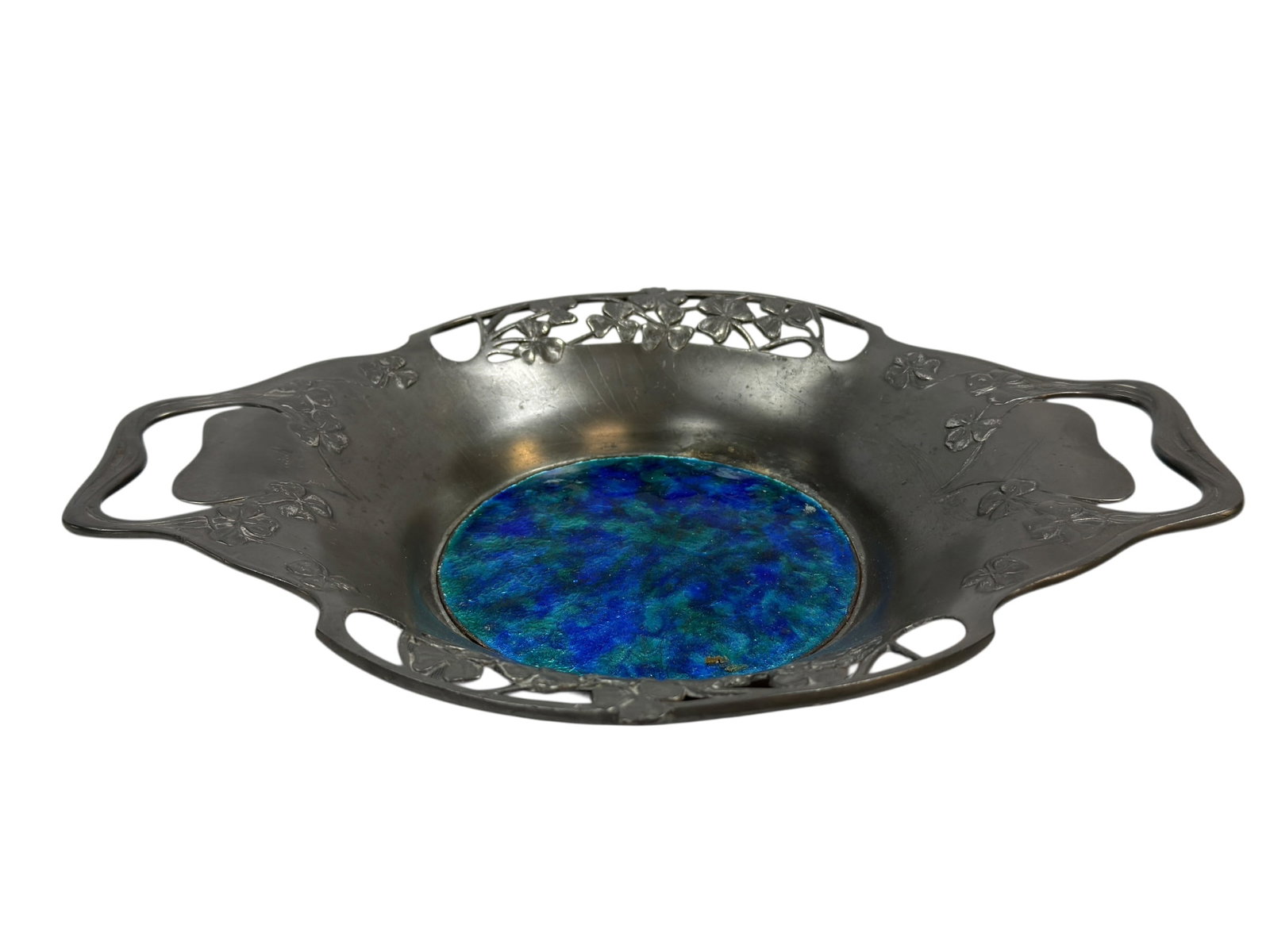 Circa 1902–1905 Liberty & Co. Tudric English Pewter & Enamel Bowl: A fine Arts & Crafts period Liberty & Co. Tudric pewter bowl, circa 1902–1905, of shallow form with twin flowing handles and an elegantly pierced rim decorated with stylized shamrock (clover) motifs
