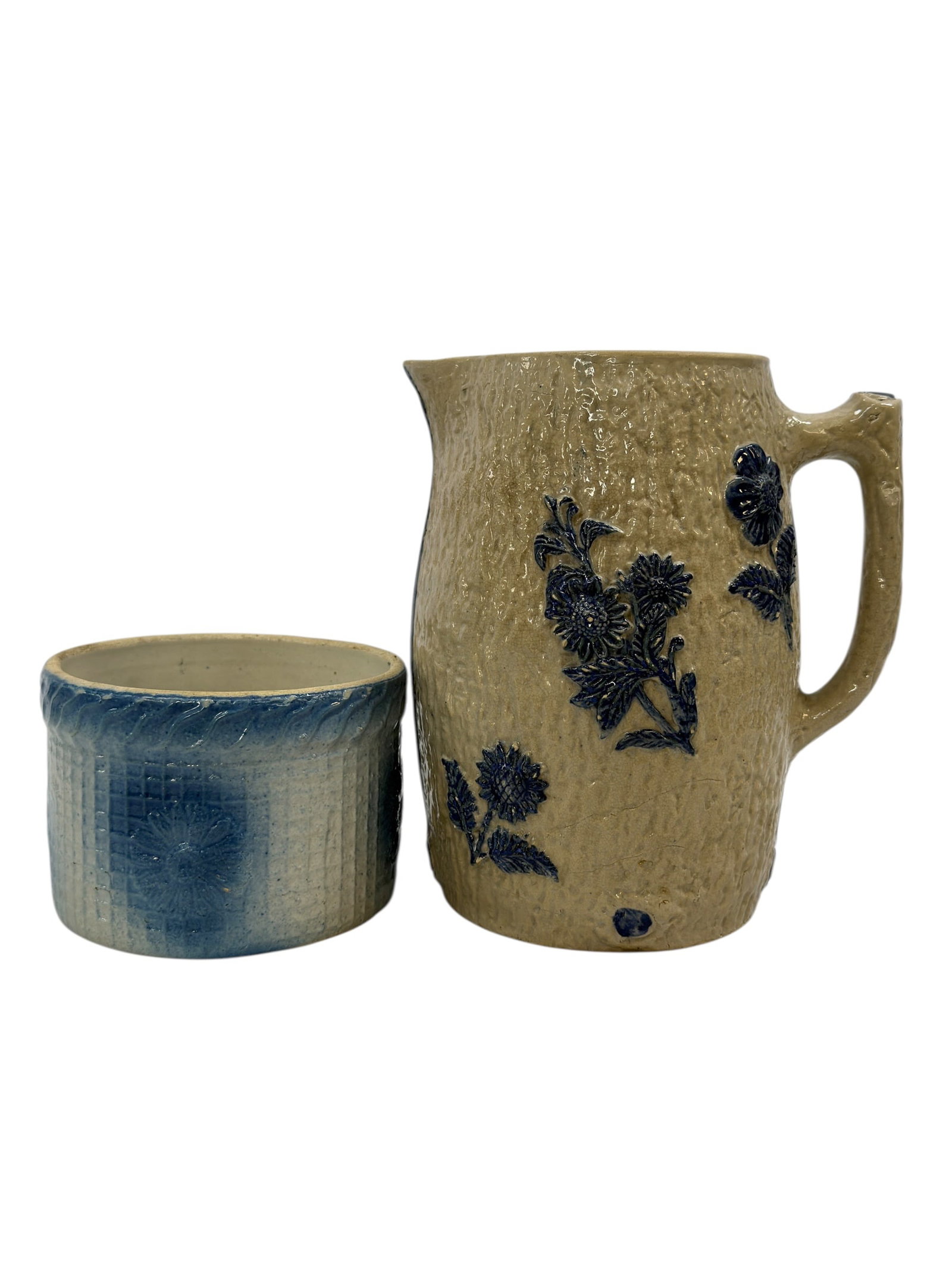 Blue & White Salt-Glazed Stoneware Pitcher & Bowl: Charming salt-glazed stoneware pieces, likely English or American, including a handled pitcher with a textured buff body adorned in cobalt blue relief floral decoration and a smaller cylindrical bowl