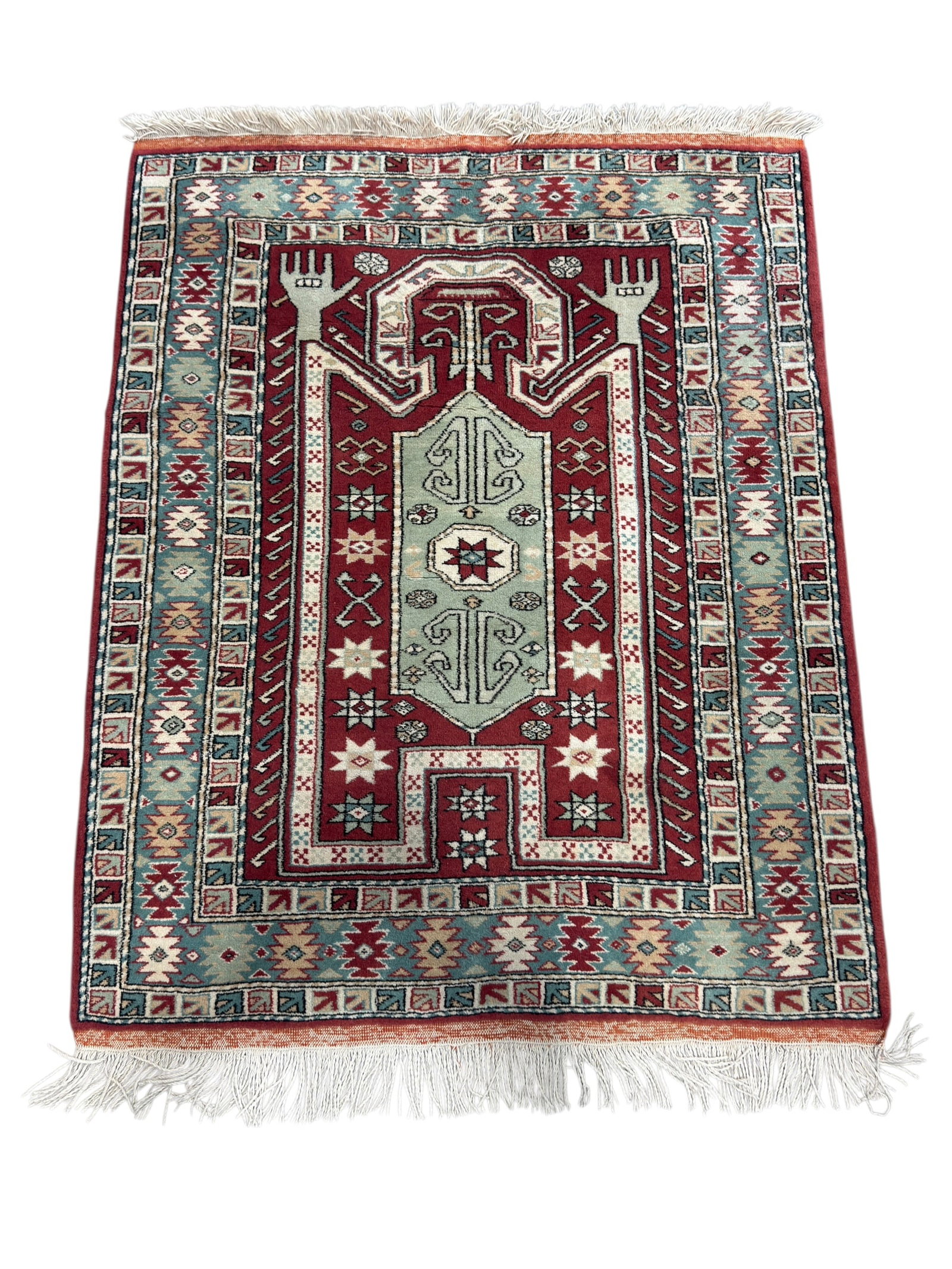 Hand-Knotted Caucasian-Style Wool Area Rug: A hand-knotted wool area rug in the Caucasian tradition, featuring a bold geometric medallion design centered within a richly colored field of deep red, pale ivory, and soft teal, surrounded by multip