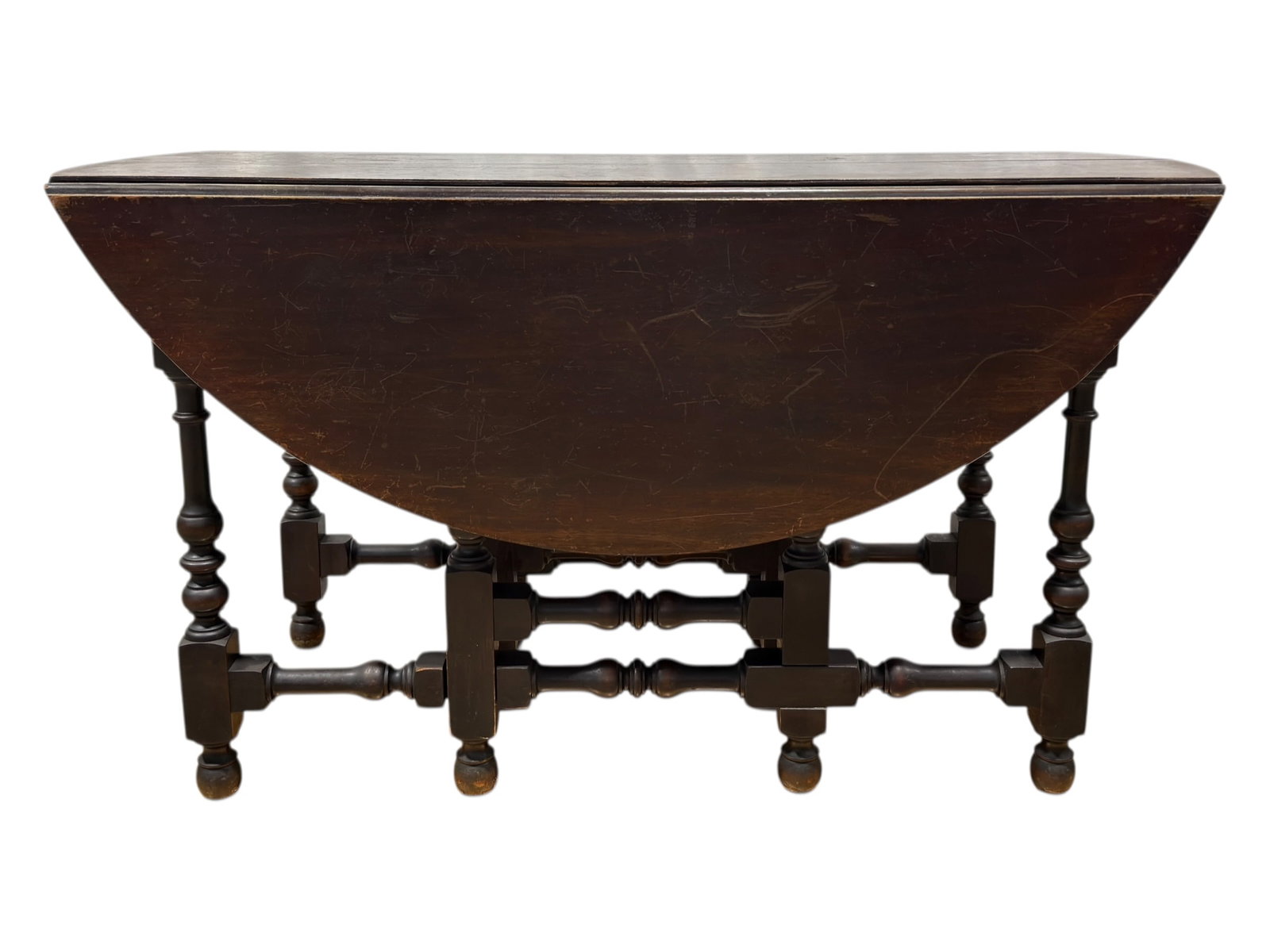 Imperial Grand Rapids Jacobean Style Drop-Leaf Dining Table: A substantial and classically styled Jacobean Revival gate-leg dining table by Imperial Furniture Company of Grand Rapids, Michigan, retaining its original maker’s label. The table features a rectan