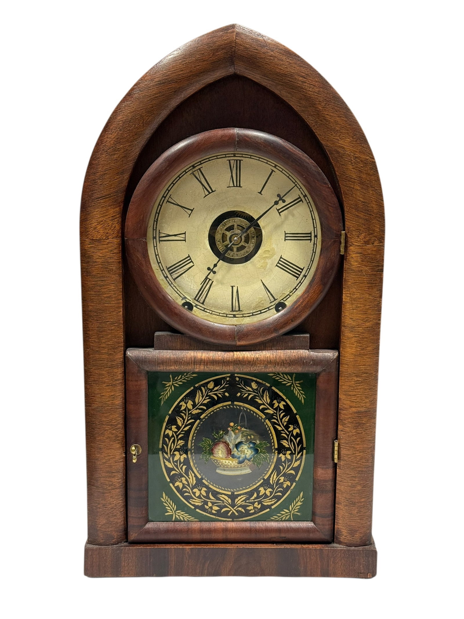 Early 20th C. American Gothic Arch Mantel Clock: Early 20th-century American mantel clock in a distinctive Gothic arch-form case, crafted from richly toned hardwood with a warm, medium-brown finish and clean vertical grain. The upper section houses