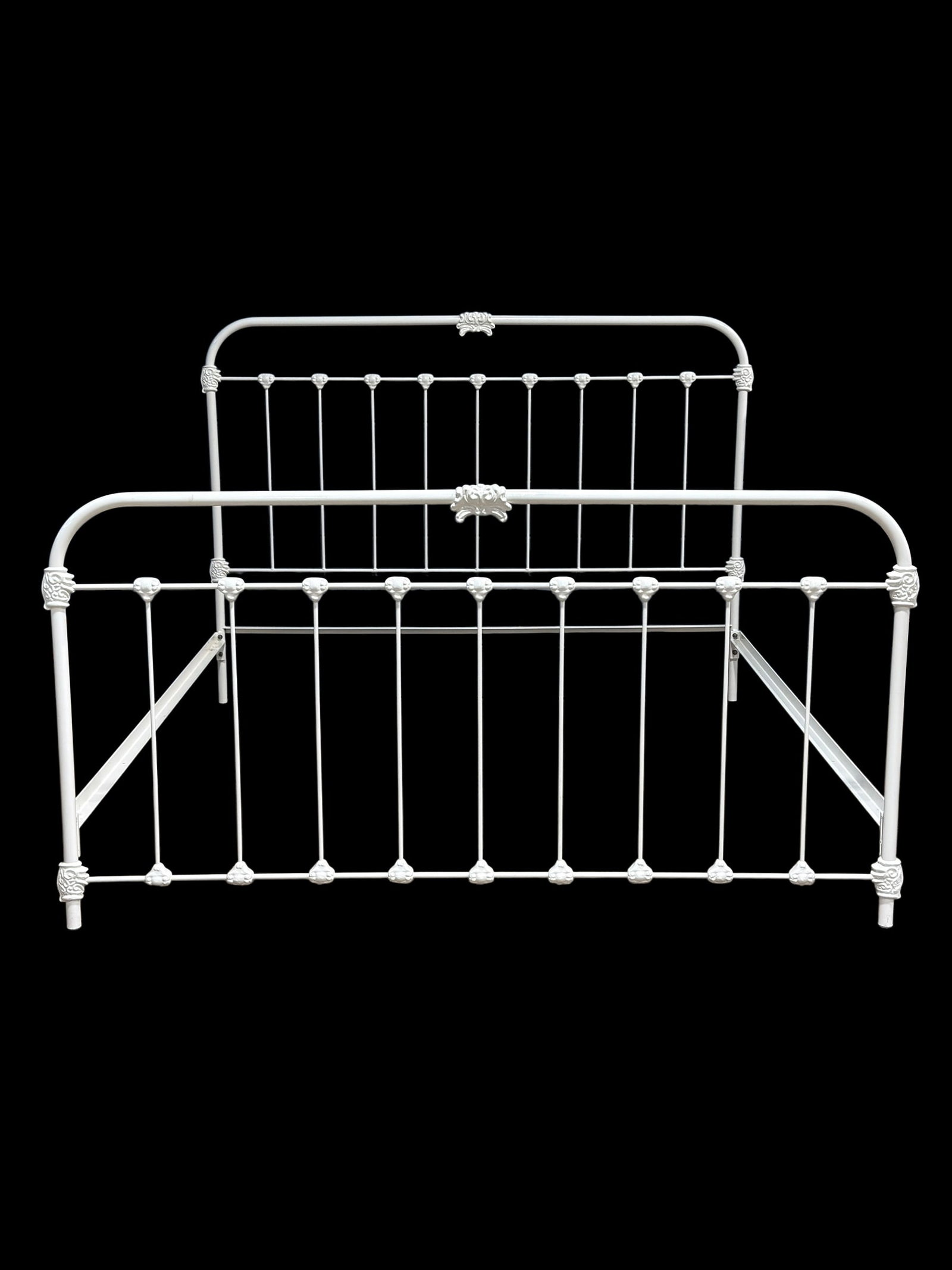 White-Painted Metal King Size Bed Frame: Vintage king size bed frame crafted of metal with a white painted finish, featuring an arched headboard and footboard with vertical spindle supports and decorative cast mounts including scrolling foli