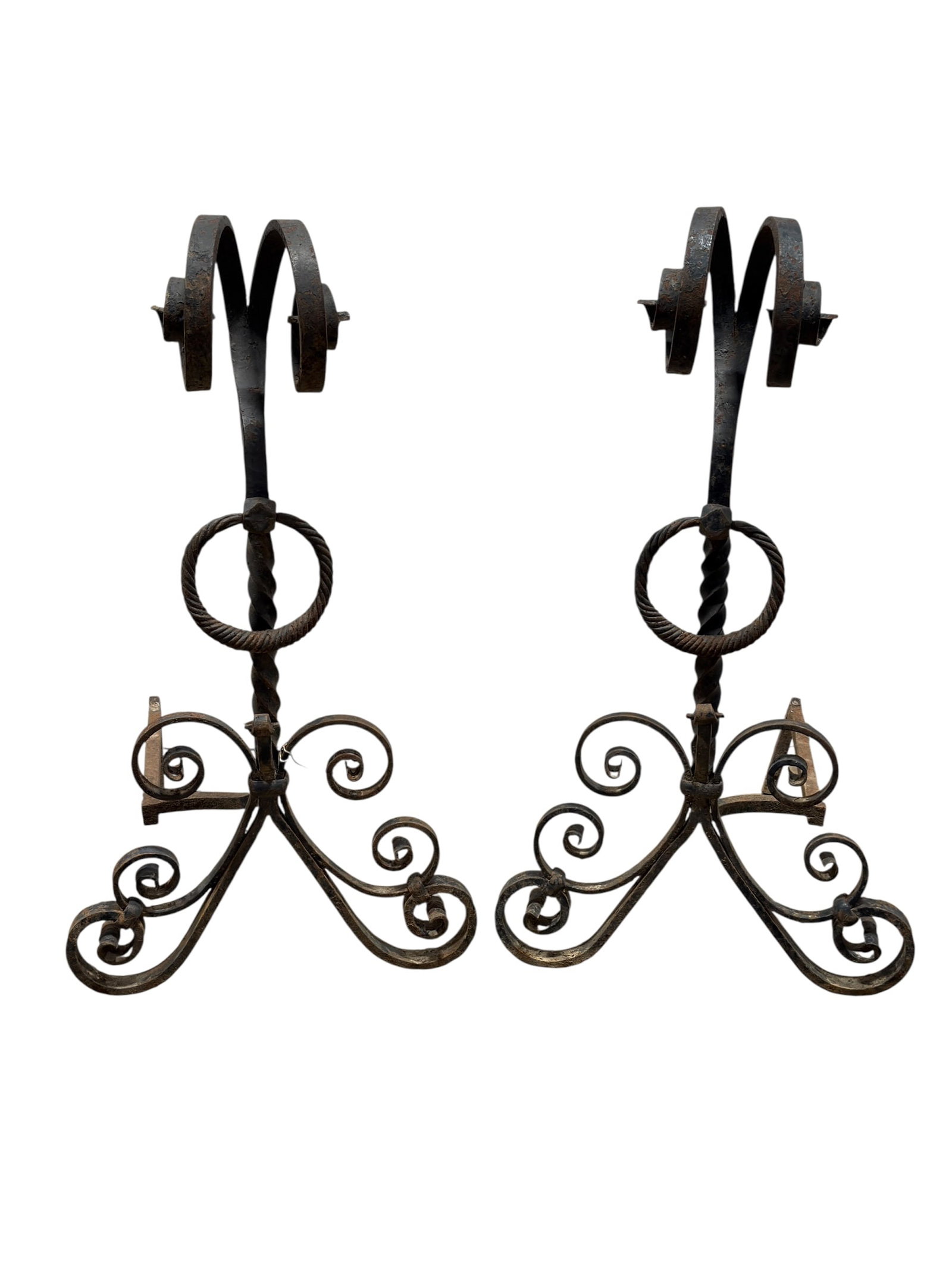 Pair of Tall Scroll Cast Iron Aindirons: Pair of cast iron fireplace andirons (fire dogs) featuring twisted vertical standards with decorative scroll-form bases and central ring handles, designed to support burning logs within a hearth while