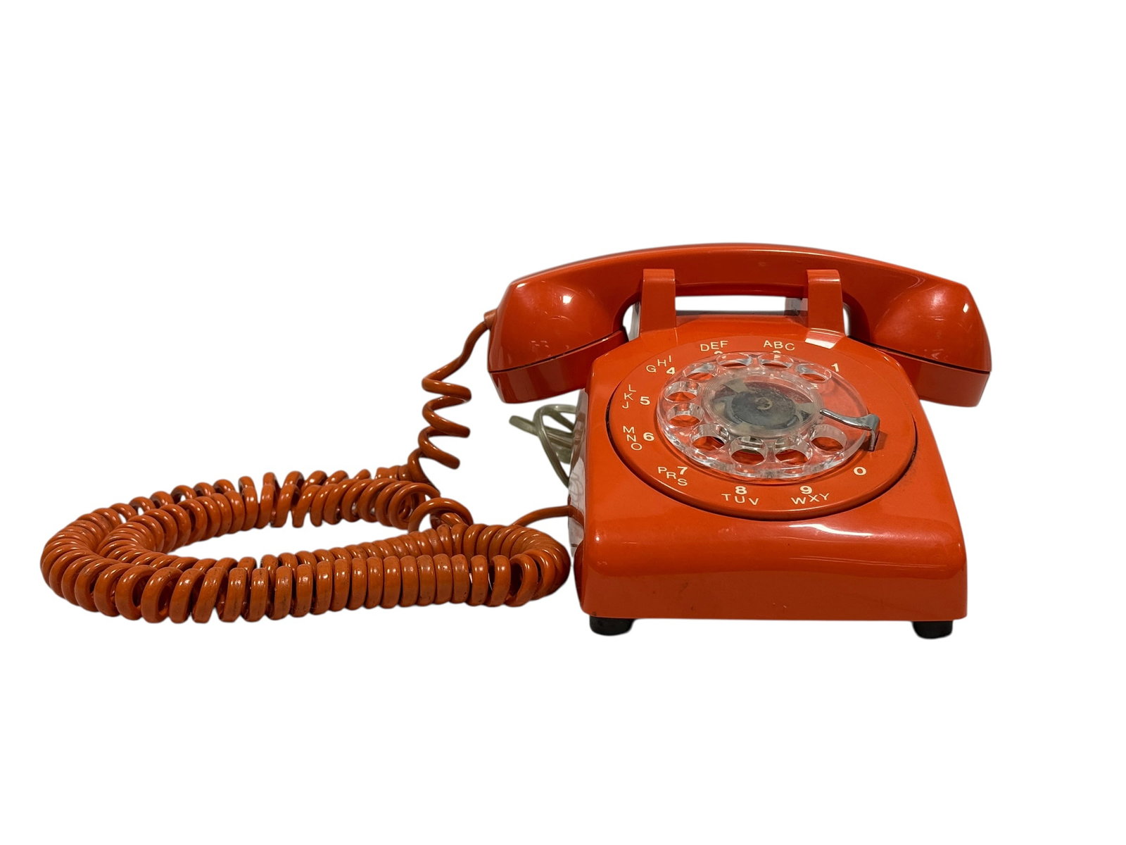 Vintage Stromberg-Carlson / Rotary Telephone Orange Desk Phone: Vintage rotary dial desk telephone in a vibrant orange finish, manufactured by Stromberg-Carlson, a respected American telecommunications company later associated with Rochester Telephone Corporation.